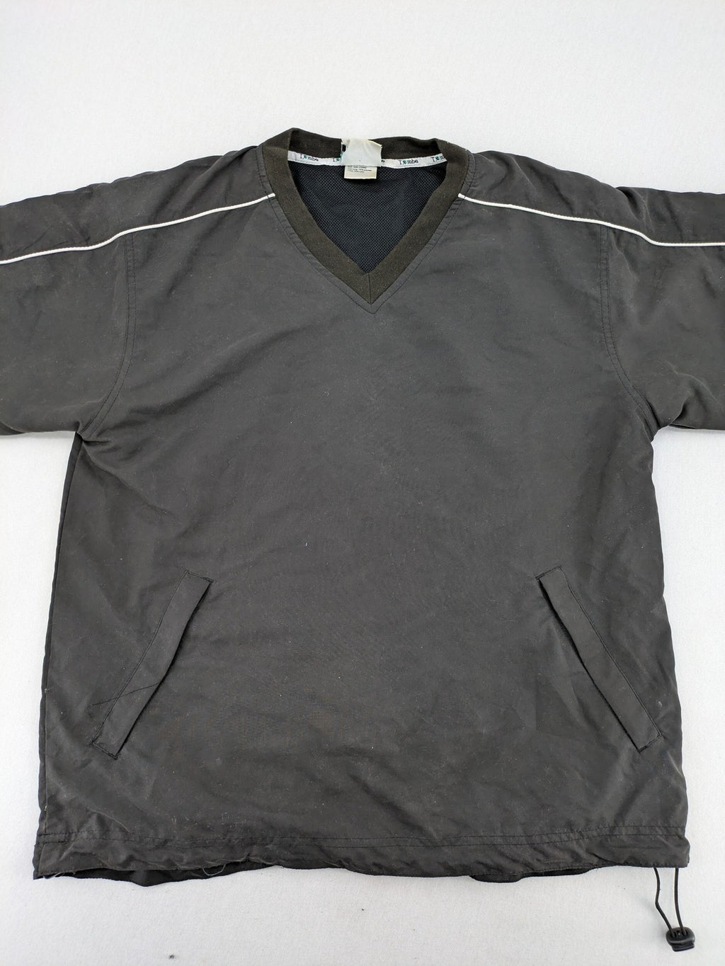 Tombo green windbreaker jacket with white piping, V-neck, and zippered pockets.