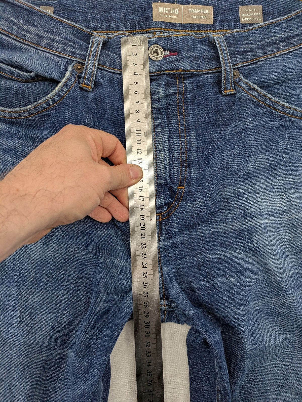 Mustang blue tapered jeans with slim fit, medium rise, and classic denim texture.
