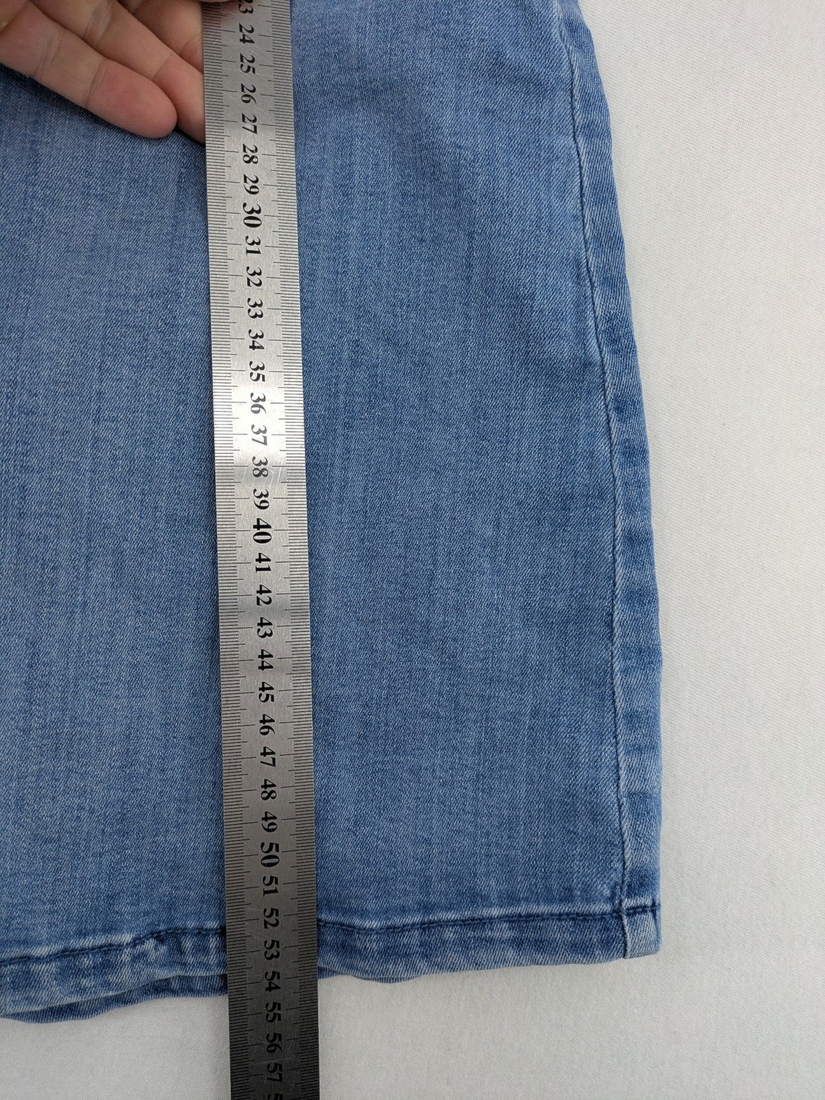 Tchibo blue A-line denim skirt classic five-pocket design with zipper and button closure.
