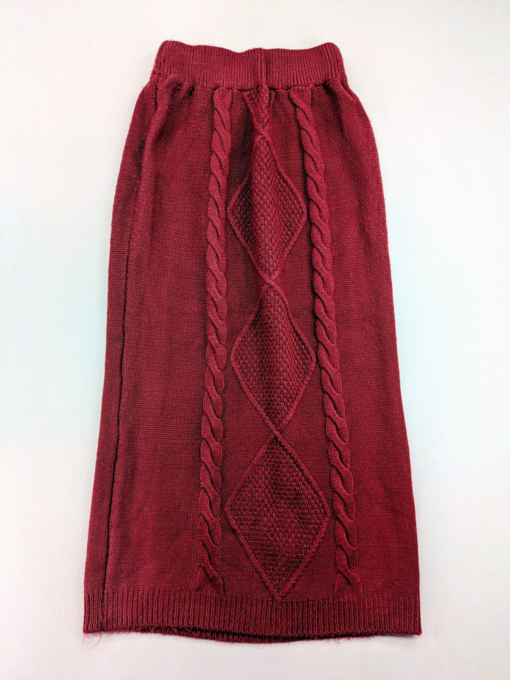 Pullover burgundy turtle neck jumper with diamond and cable knit patterns, elastic waistband.
