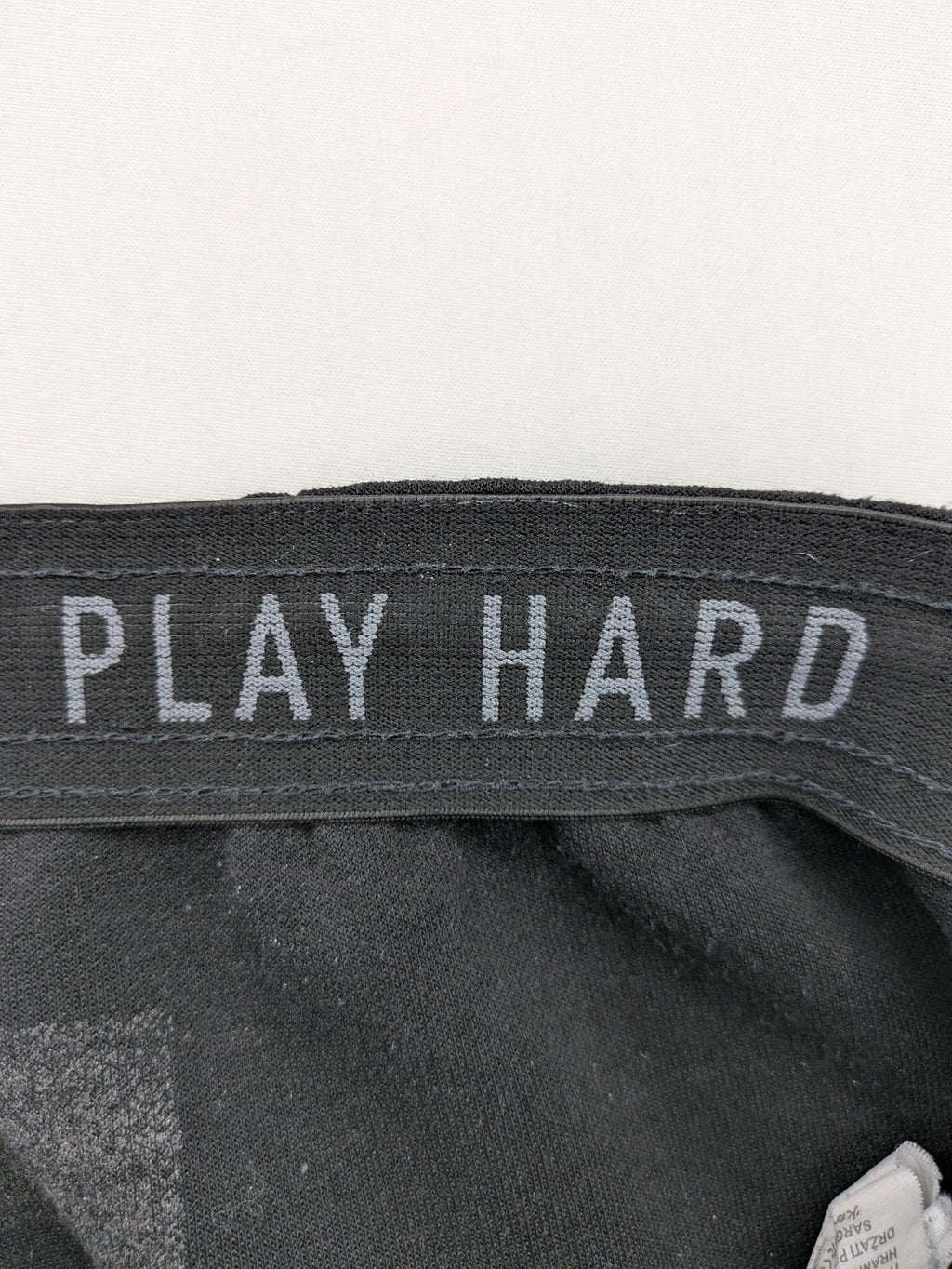 K1X grey joggers with white basketball logo, elastic waistband, and cuffed ankles.