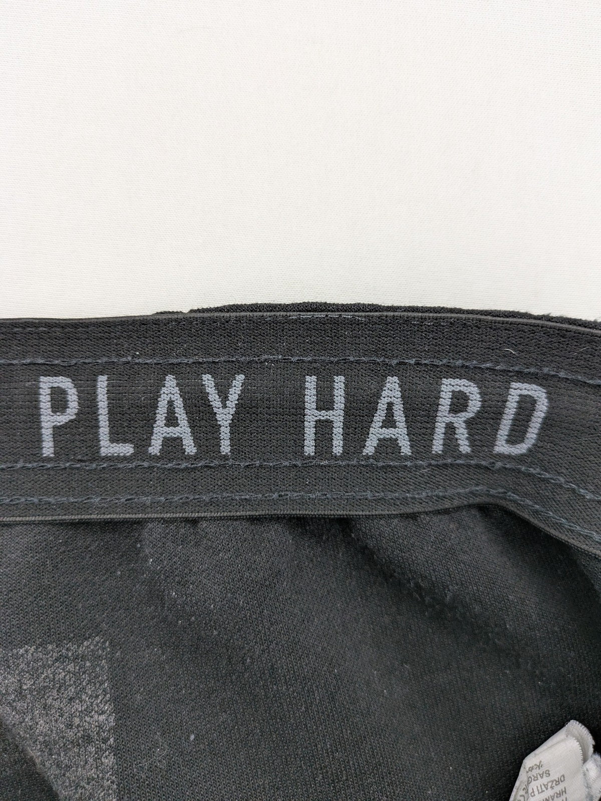 K1X grey joggers with white basketball logo, elastic waistband, and cuffed ankles.