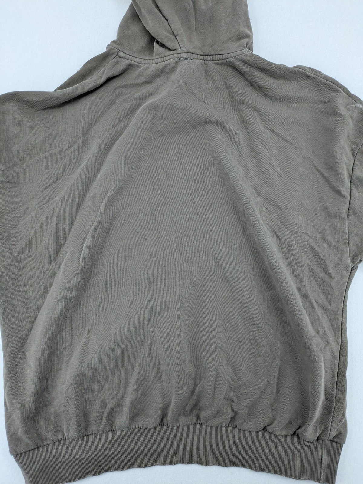 Mosquito grey hoodie with distressed cuffs and subtle logo on the chest.