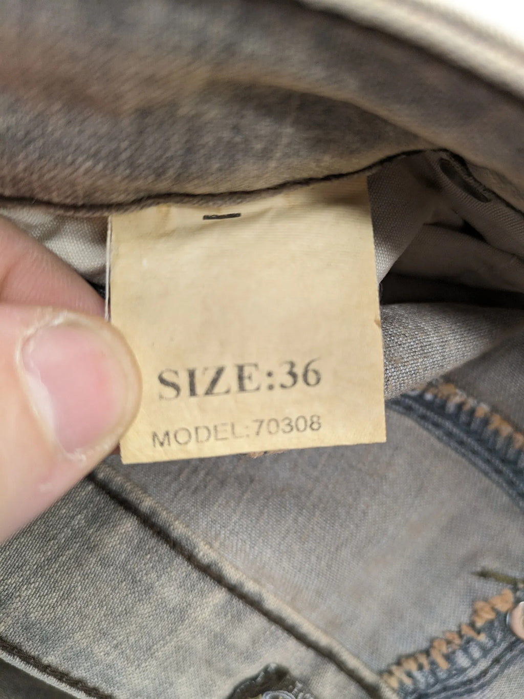 Masha khaki straight jeans with rhinestone embellishments and decorative stitching.