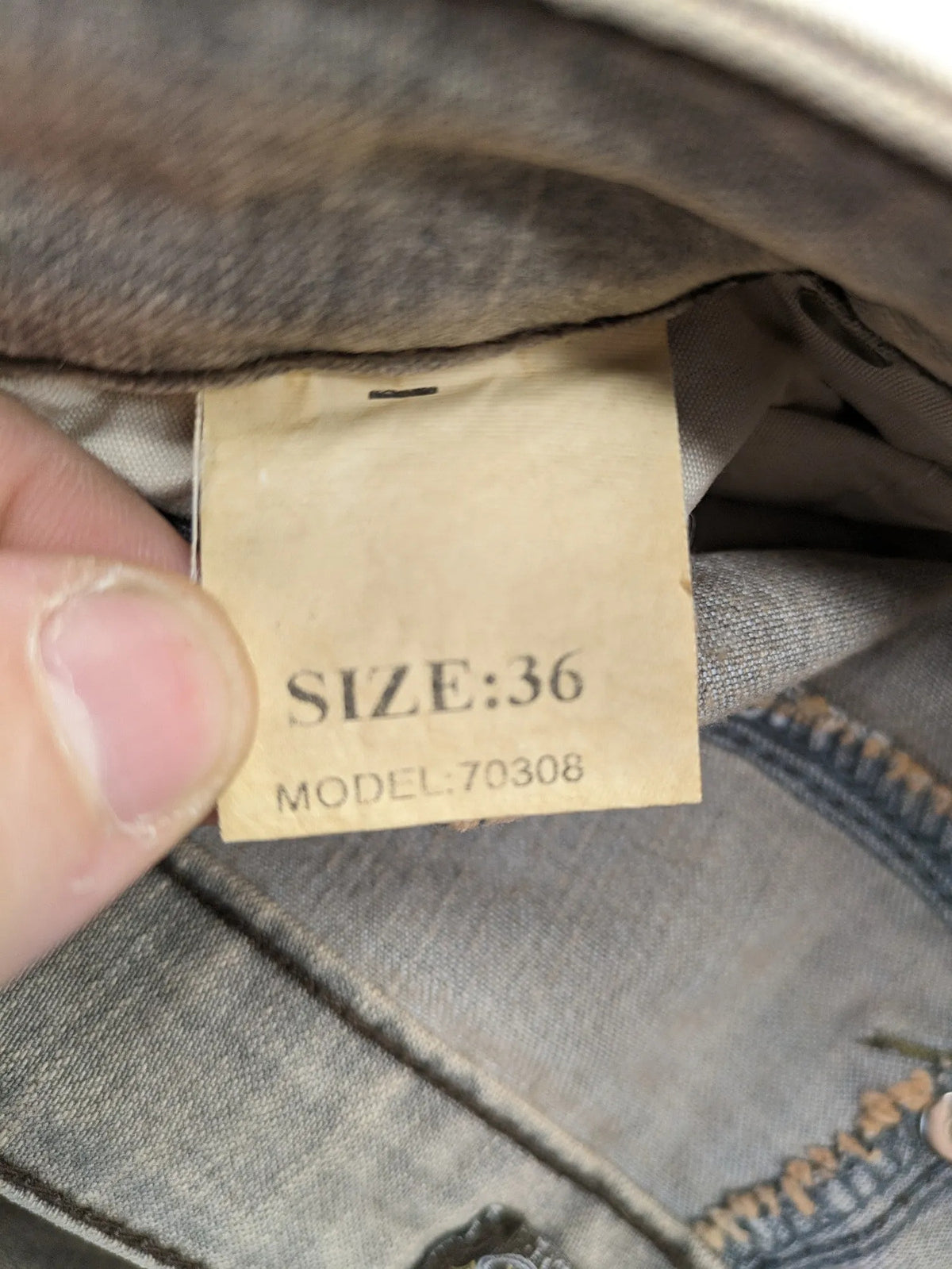 Masha khaki straight jeans with rhinestone embellishments and decorative stitching.
