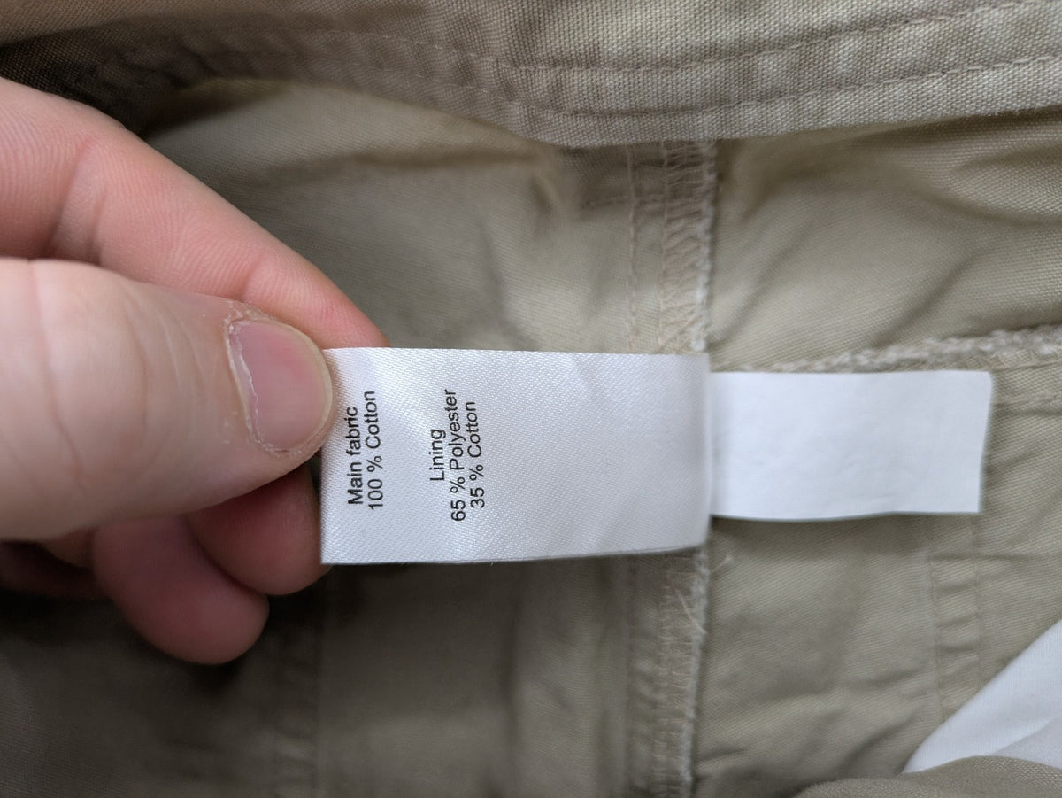 Quechua khaki convertible hiking pants with zip-off legs and durable cotton fabric.