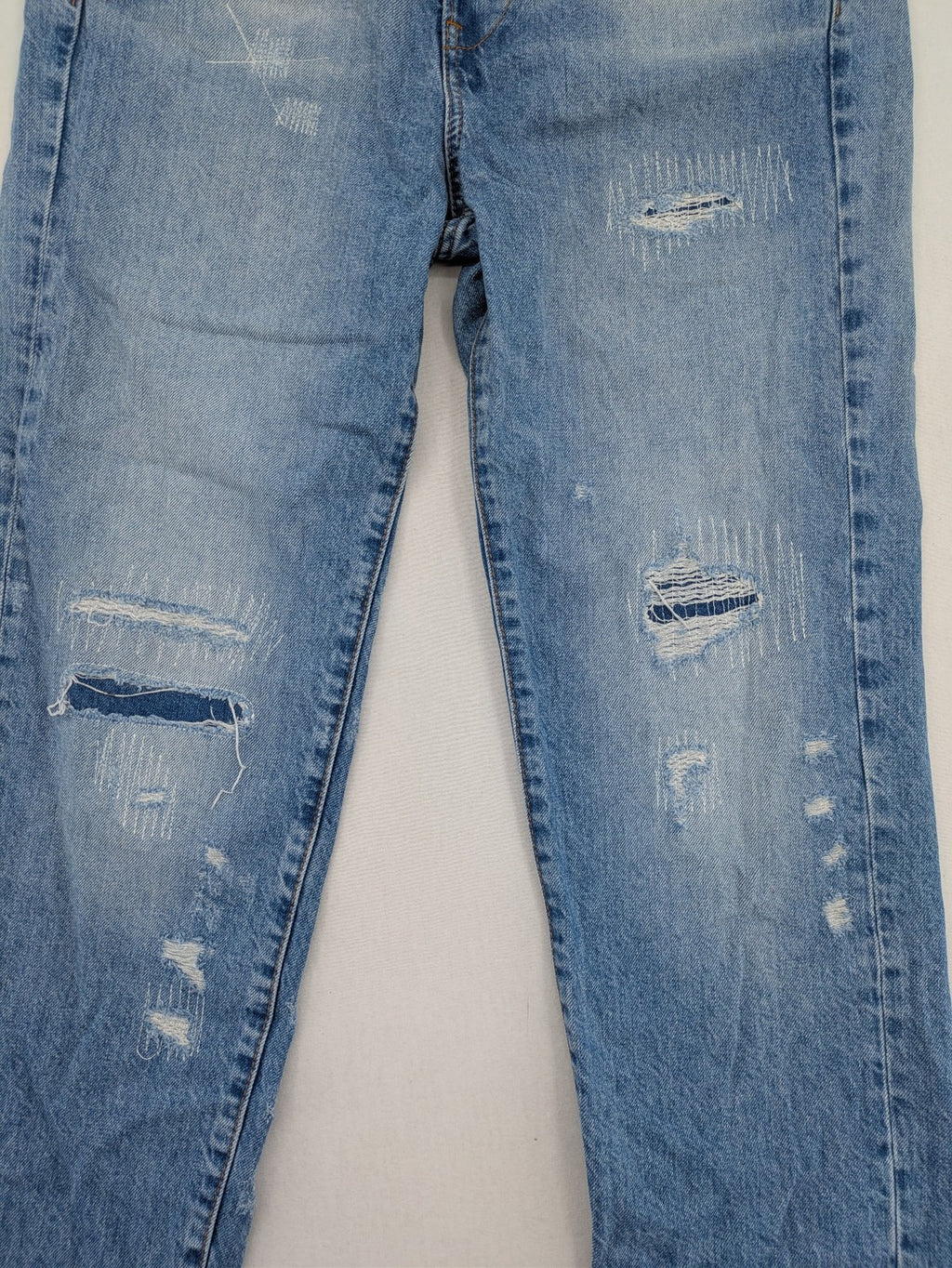 G-Star Raw blue distressed high boyfriend jeans with ripped details and classic button closure.