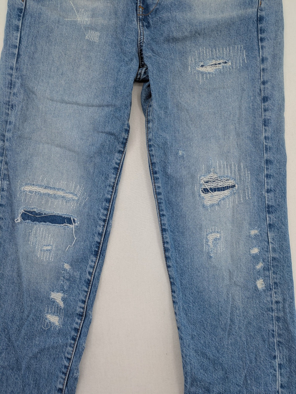 G-Star Raw blue distressed high boyfriend jeans with ripped details and classic button closure.