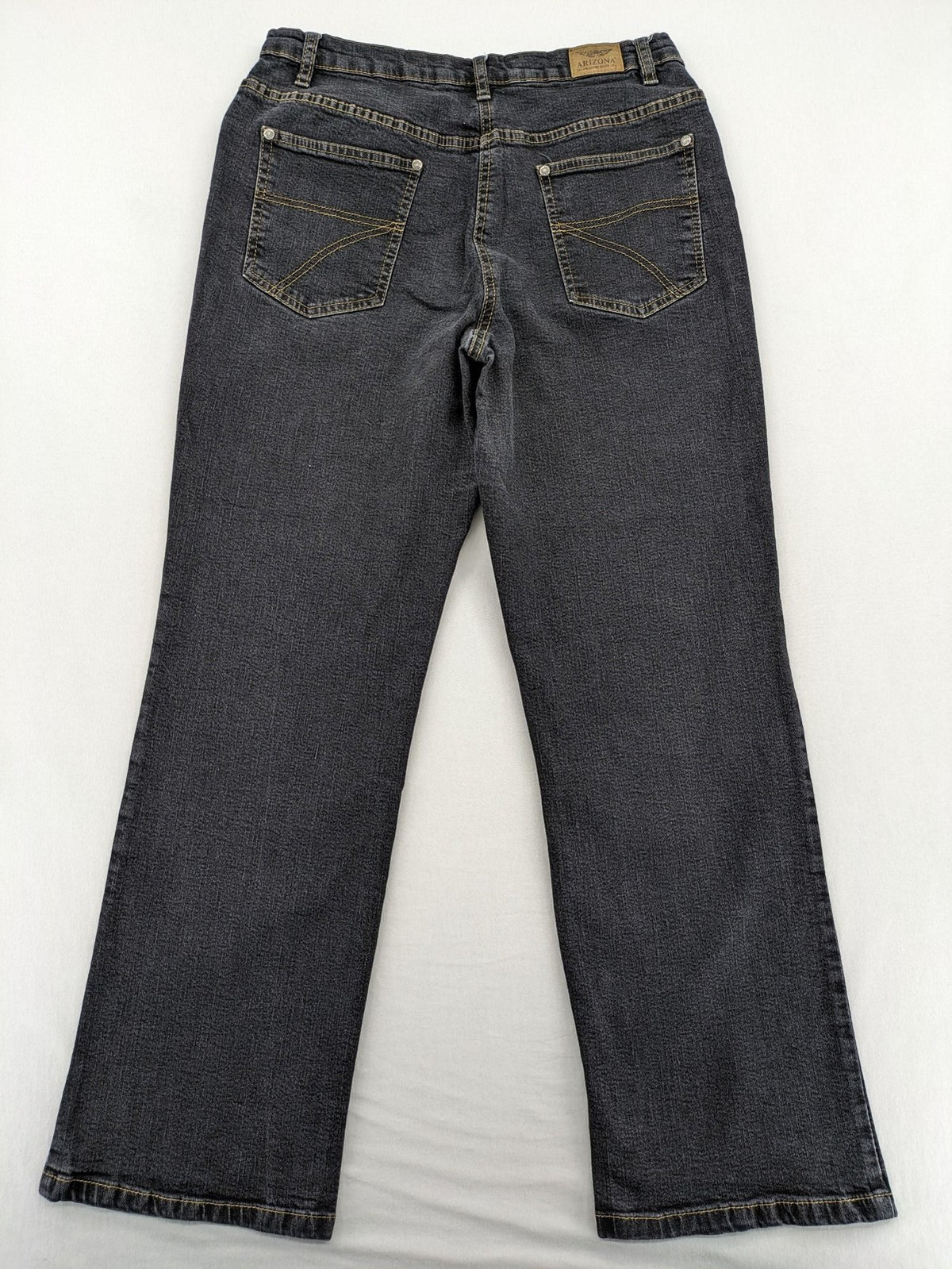 Bootcut grey low rise bootcut jeans five-pocket design with zipper and button closure.