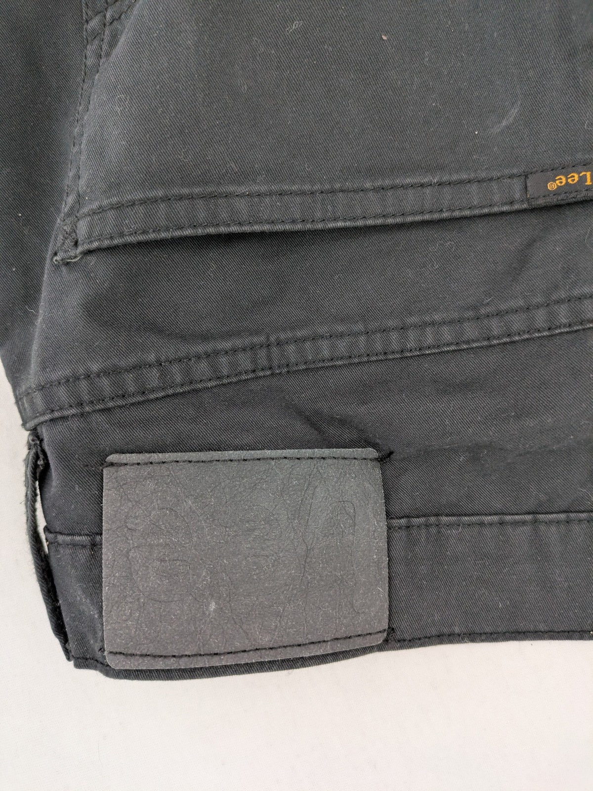 Lee straight jeans grey classic 5-pocket design with zip fly and subtle branding.