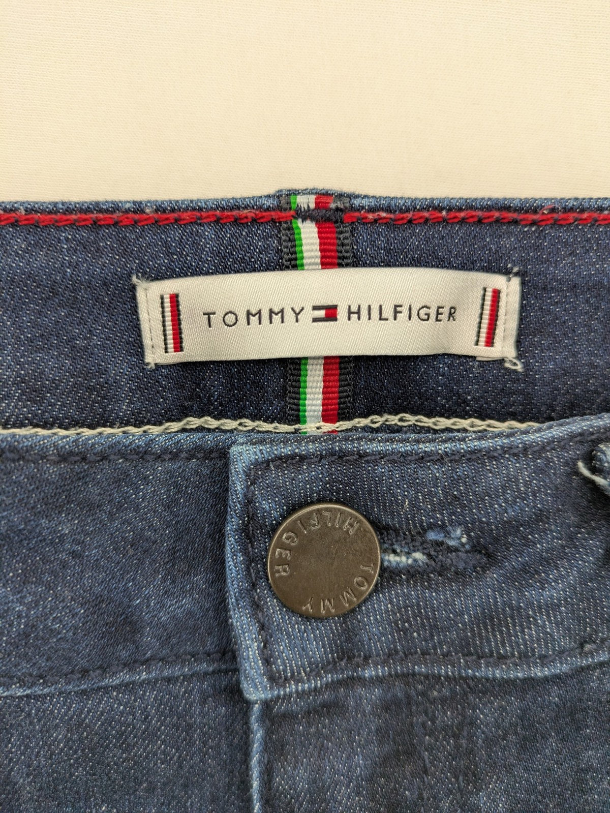 Tommy Hilfiger blue straight jeans with iconic logo and dark wash denim finish.