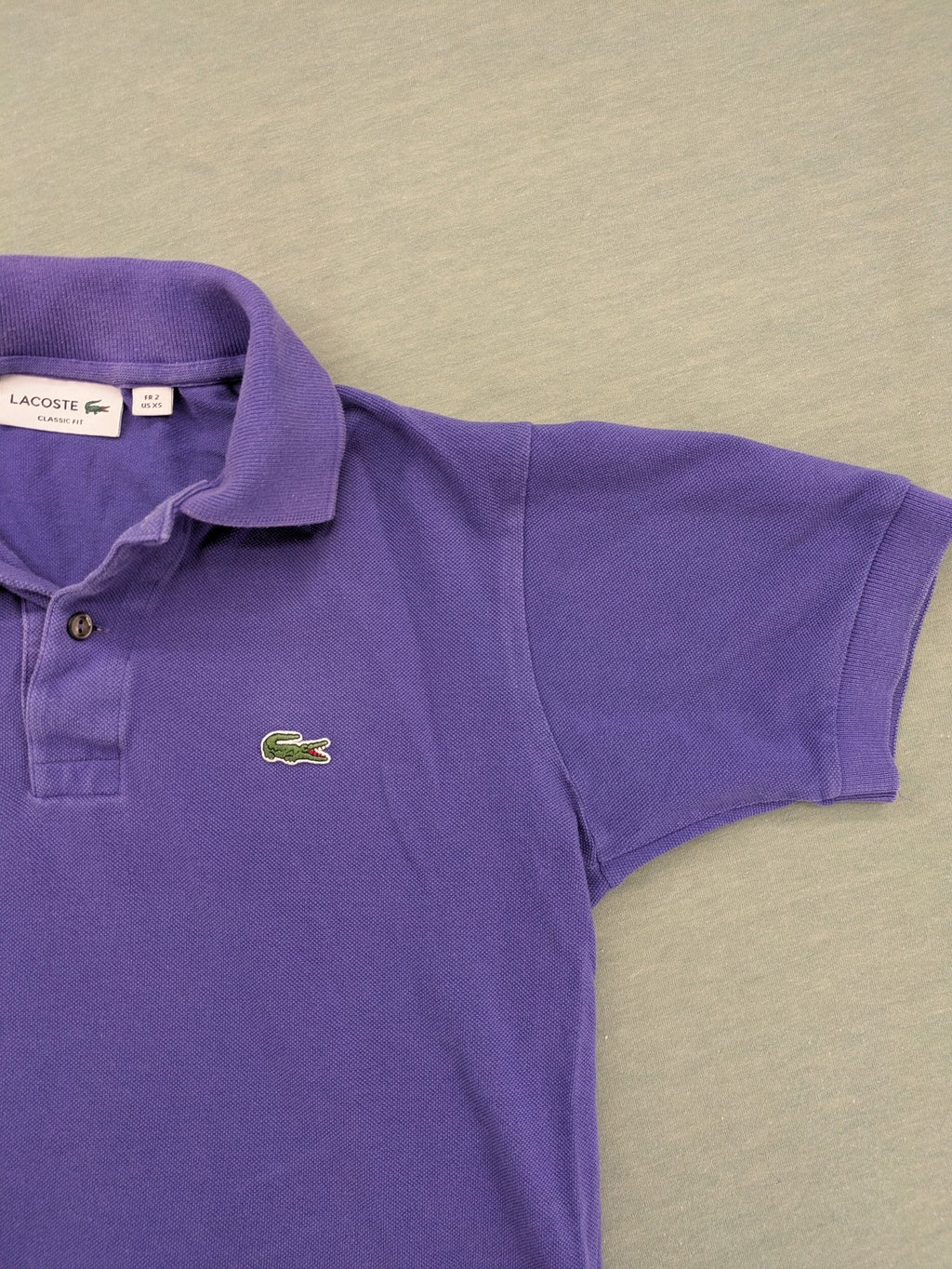 Lacoste purple polo shirt classic fit with embroidered crocodile logo and short sleeves.