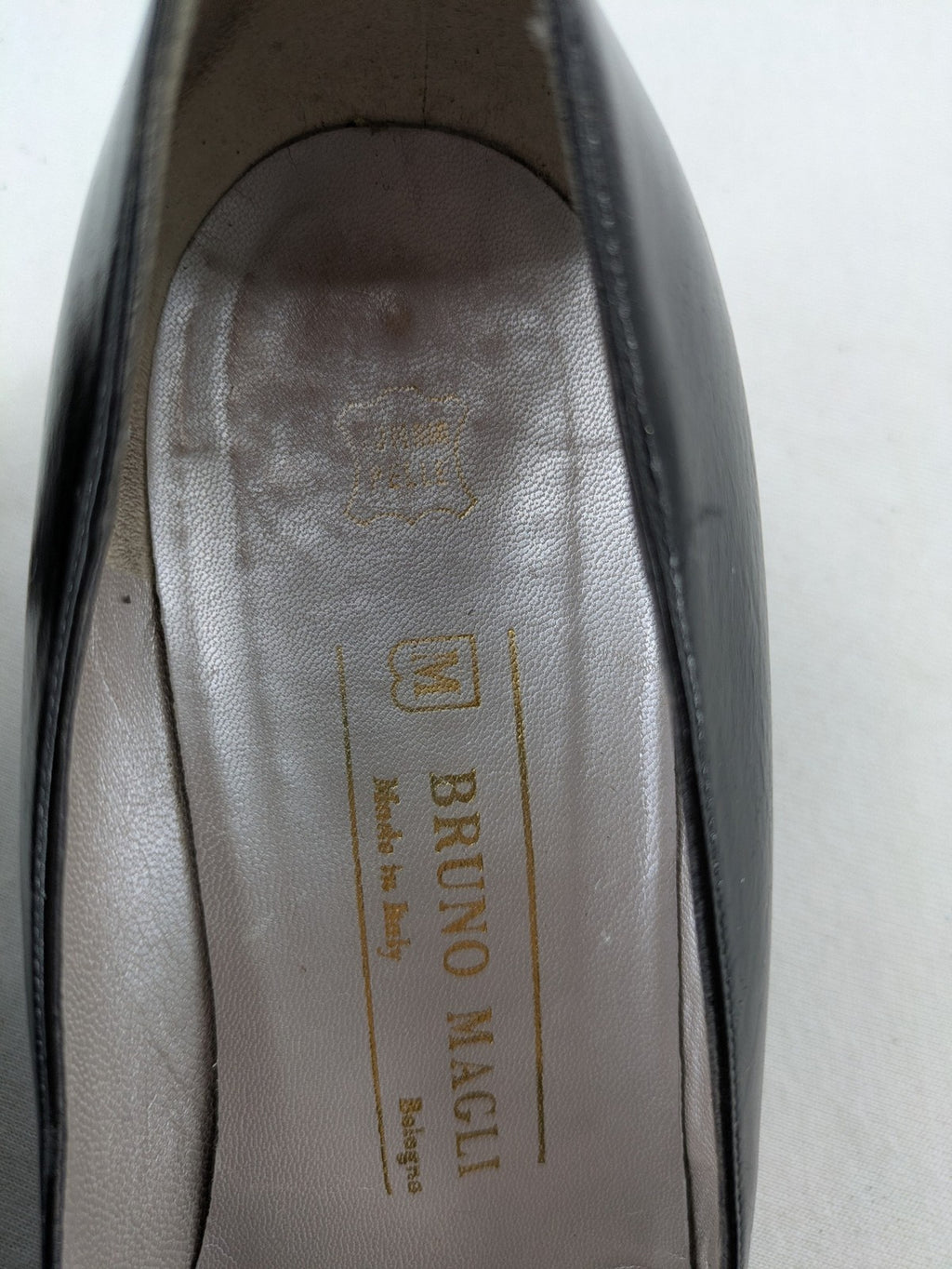 Bruno Magli black high heels leather with grey bow detail and classic silhouette.