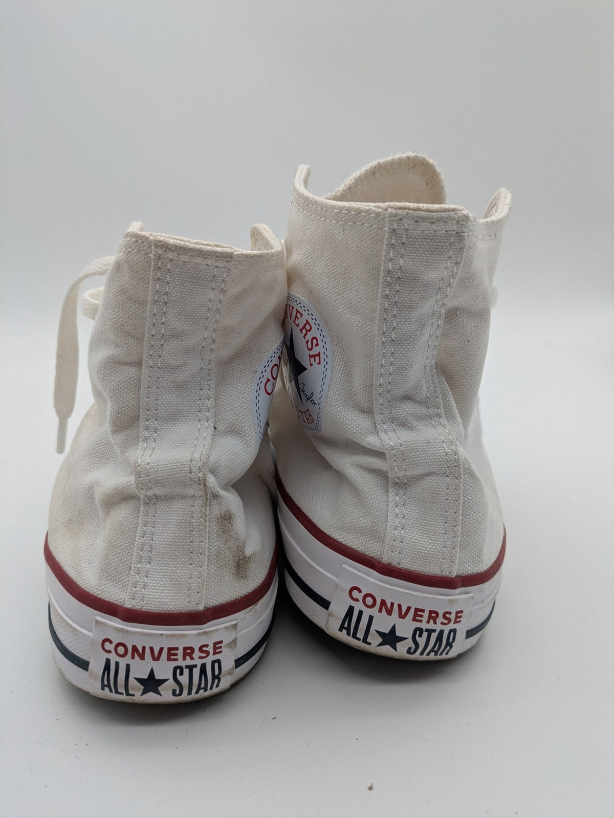 Converse Chuck Taylor All Star high top sneakers black canvas with red and white accents.