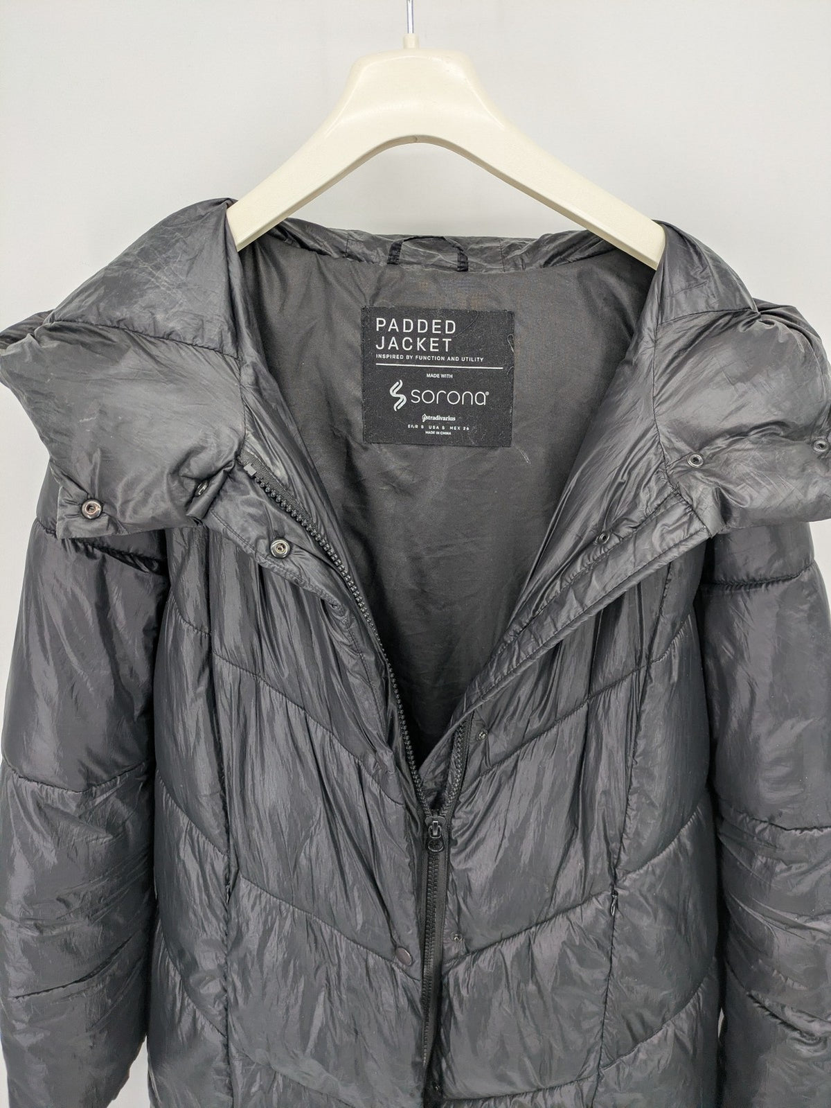 Stradivarius grey coat with chevron quilted pattern and hood, featuring zip closure and snap storm flap.
