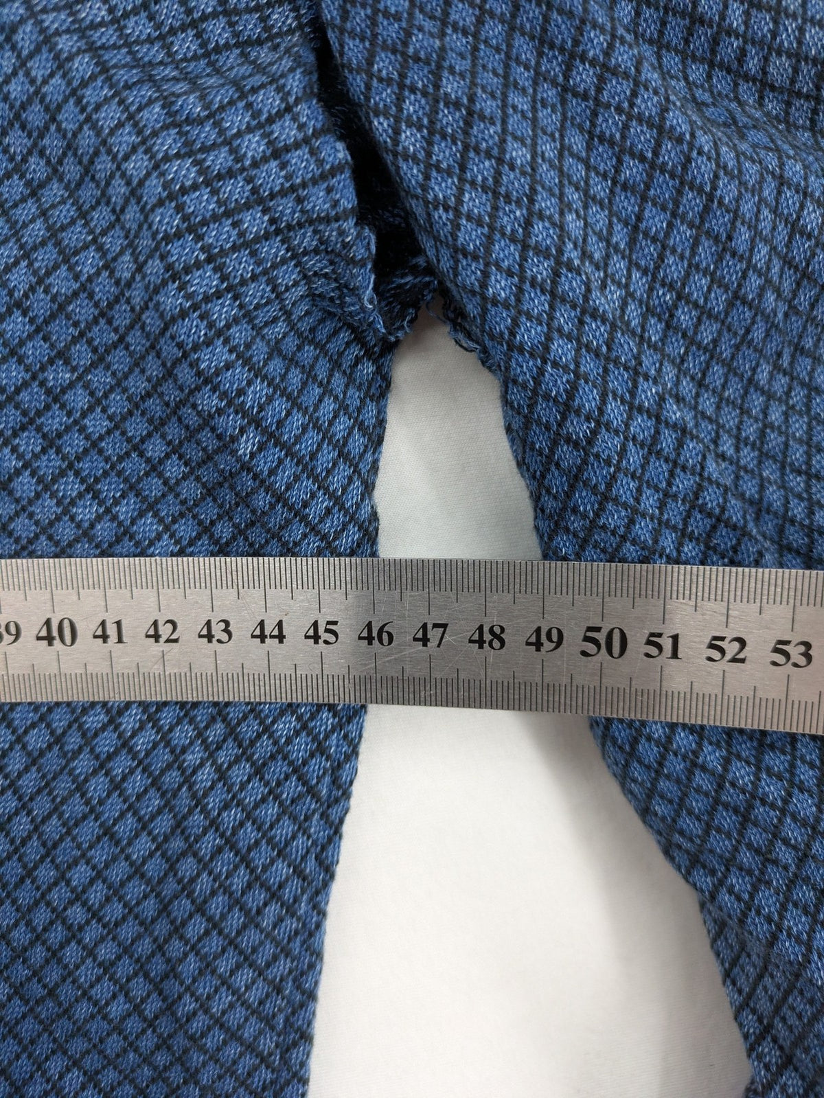 Gas blue turtle neck jumper with diamond pattern, three-button Henley neck, and contrasting trim.