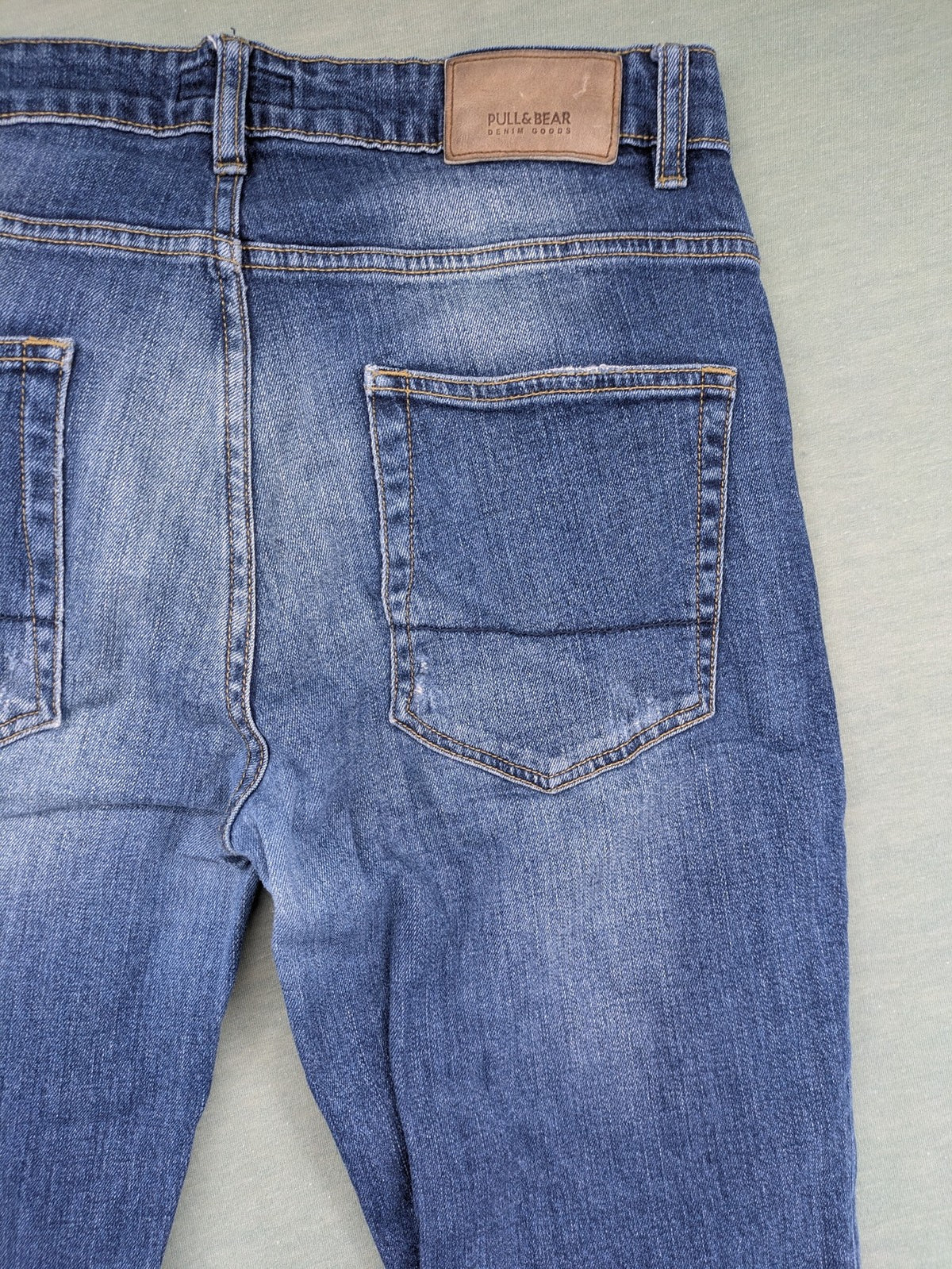 Pull & Bear blue distressed ripped straight jeans with button fly and classic wash.