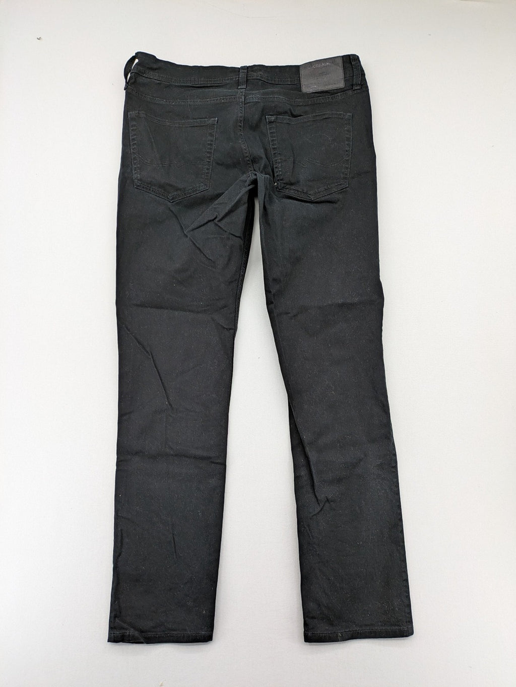 Jack & Jones black slim fit jeans with logo patch and cotton-stretch blend.