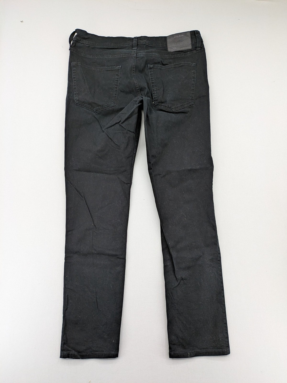 Jack & Jones black slim fit jeans with logo patch and cotton-stretch blend.