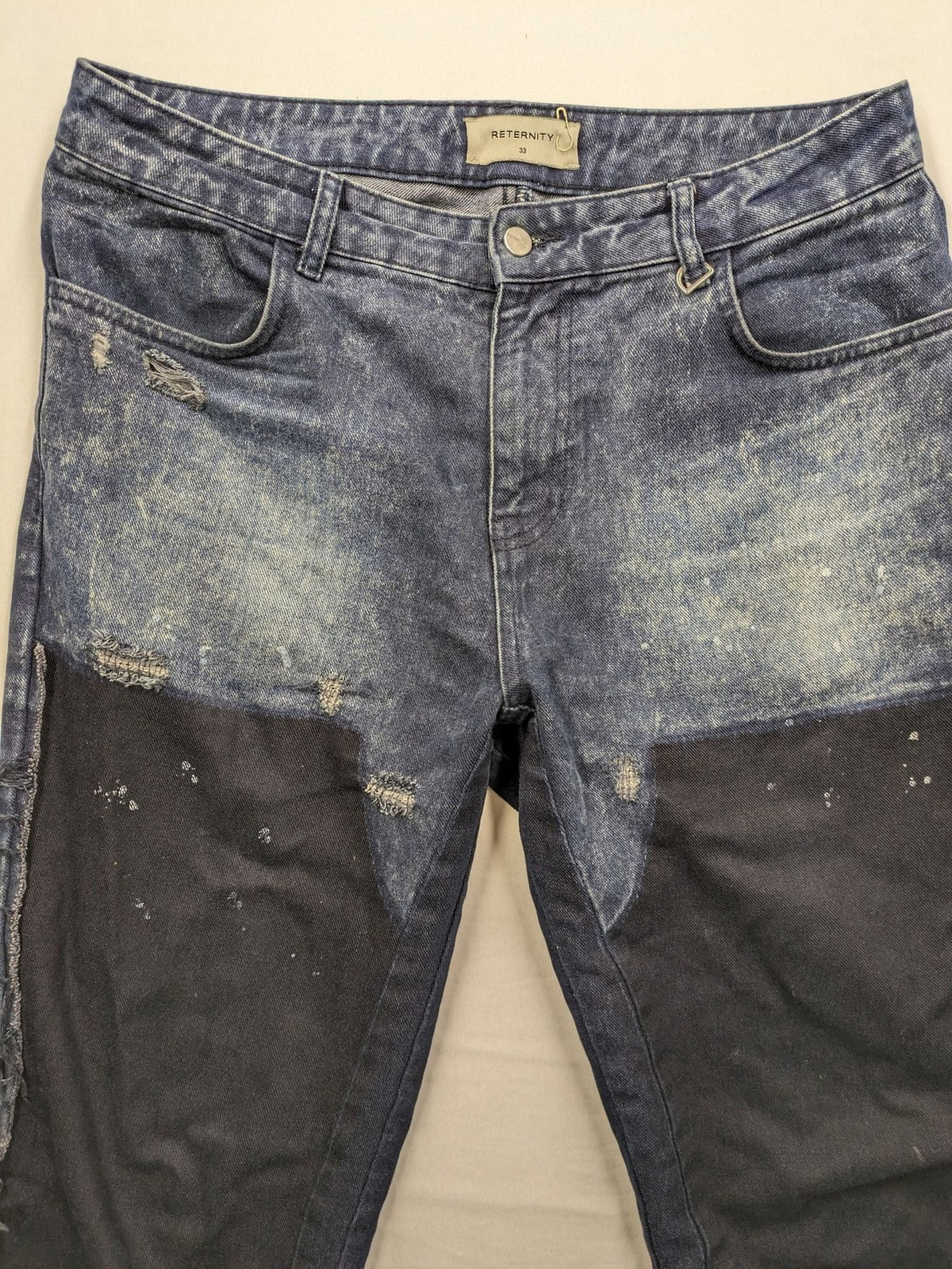 Reternity straight jeans blue black patchwork design with distressed details and frayed seams.