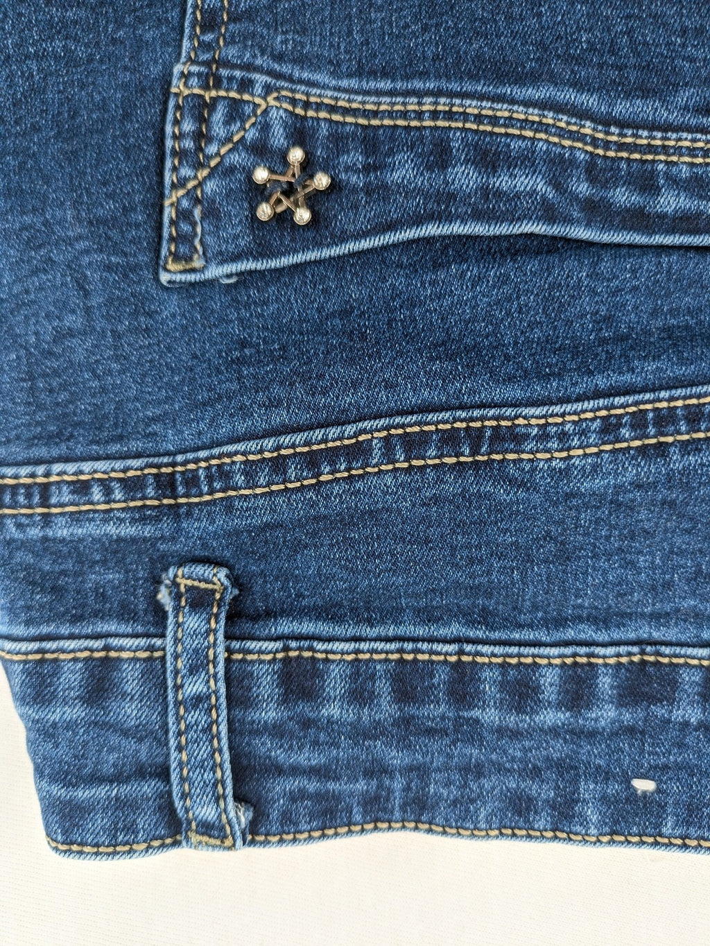 Miss Good blue straight jeans with 5-pocket design and decorative metal accent.