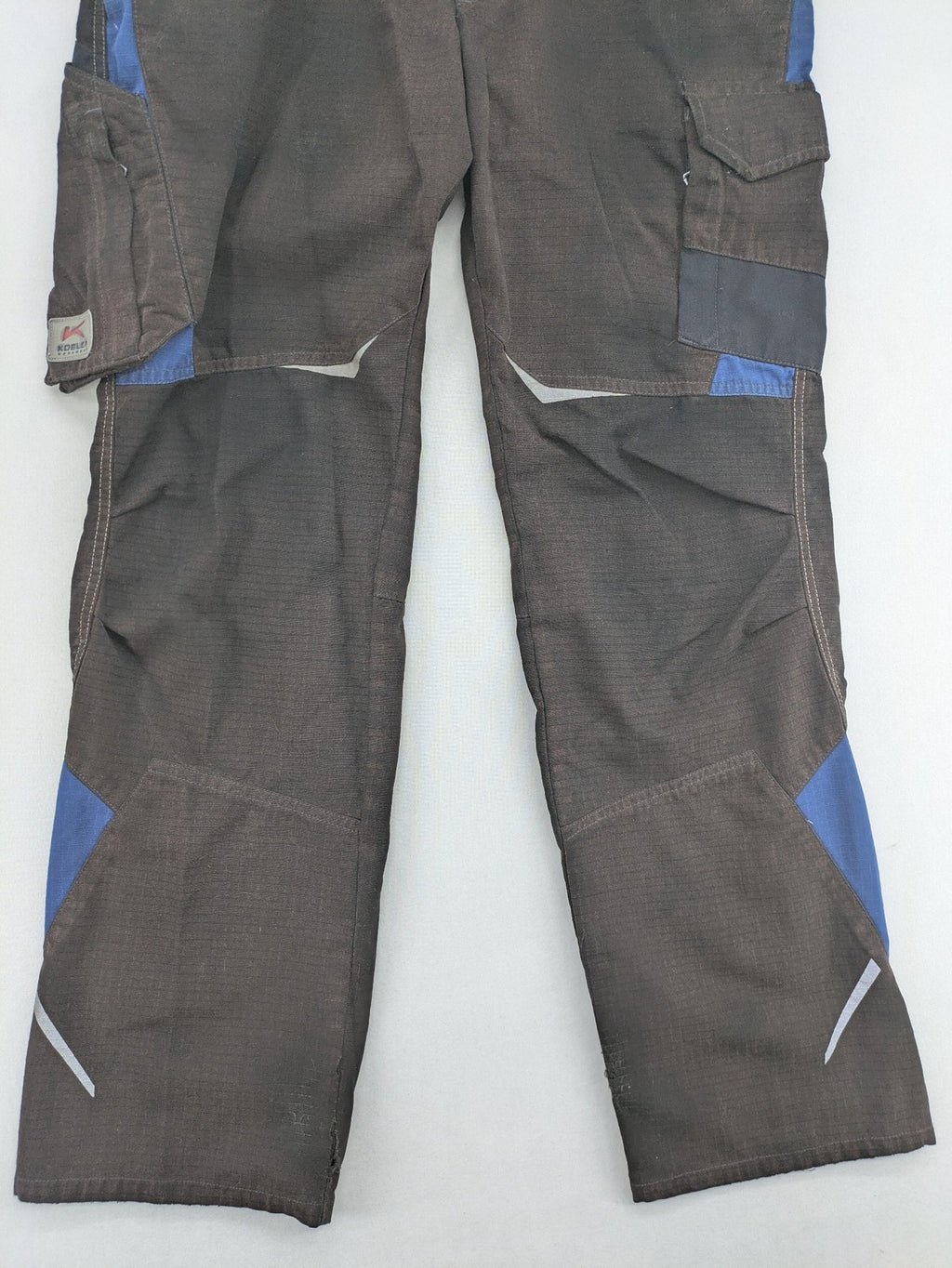 Kübler work pants blue grey Cordura fabric with multiple cargo pockets and reflective details.