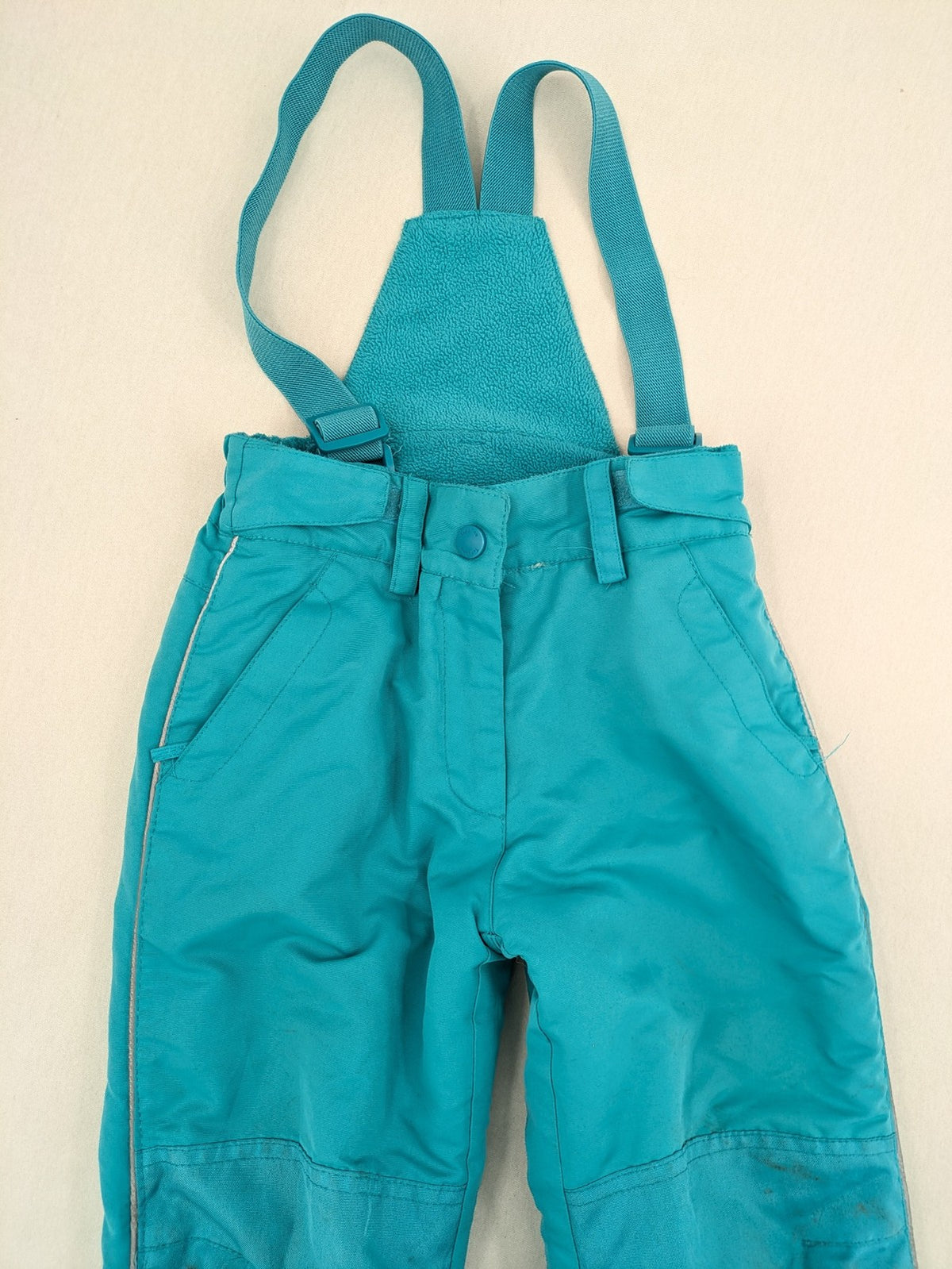 Topolino blue and turquoise snow pants with adjustable straps and fleece-lined bib.