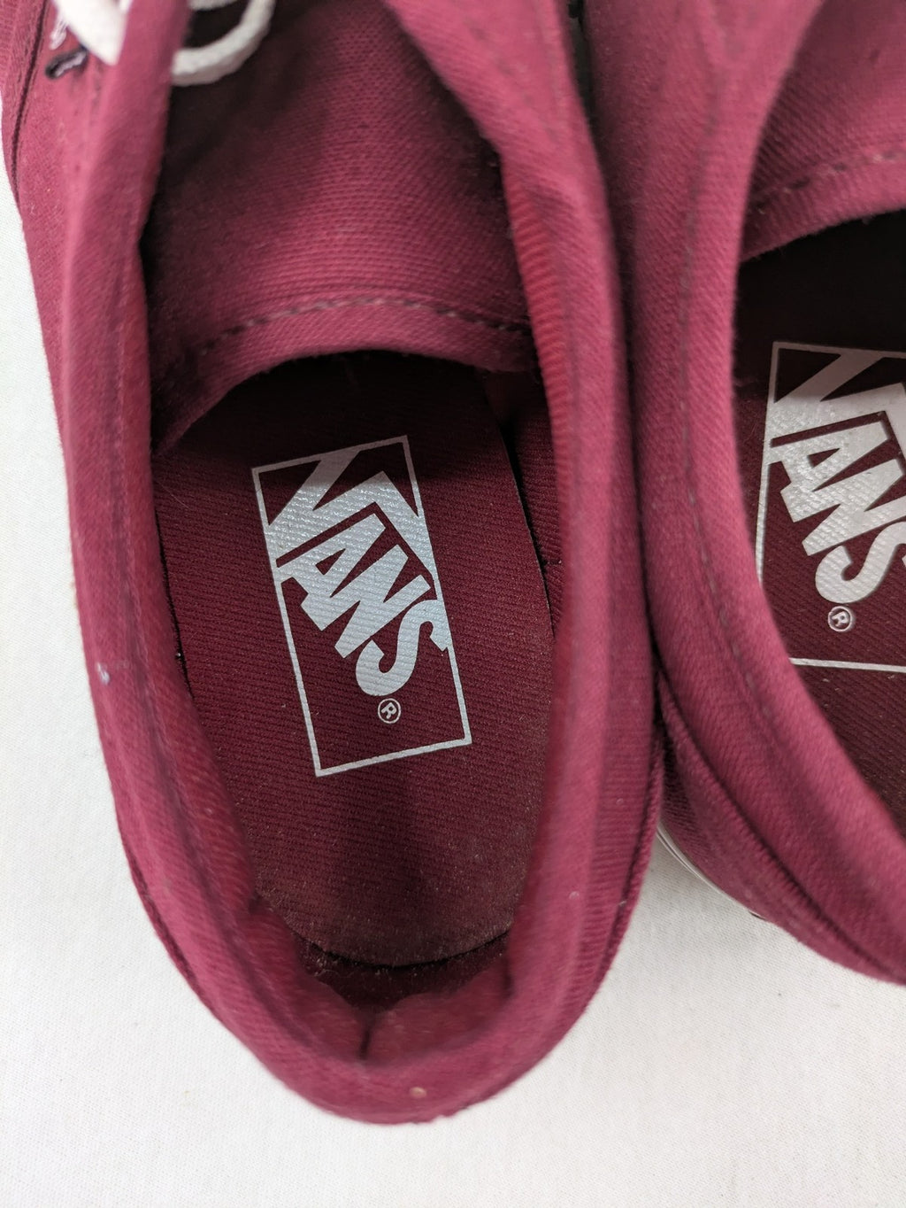 Vans low-top sneakers burgundy canvas with white logo and classic waffle sole.