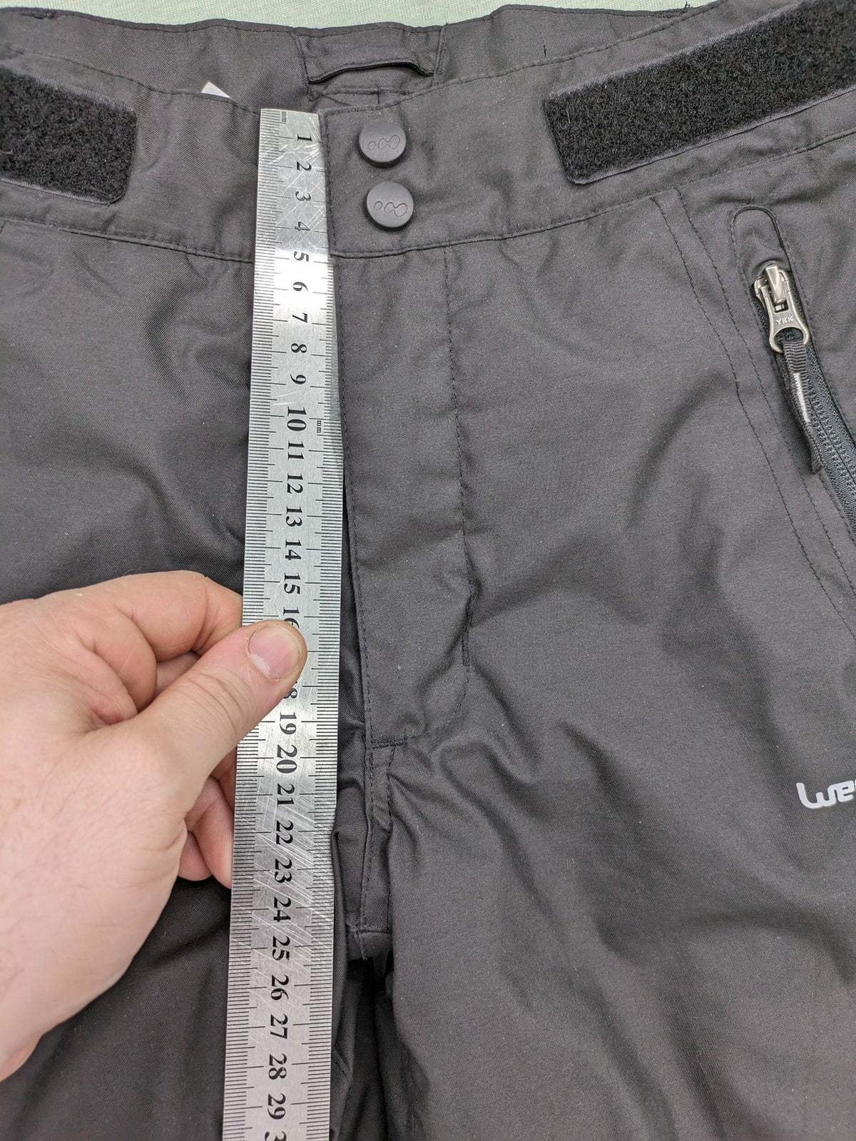 Wed'ze black ski pants with adjustable waistband, zip pockets, and Pull'n'Fit system.