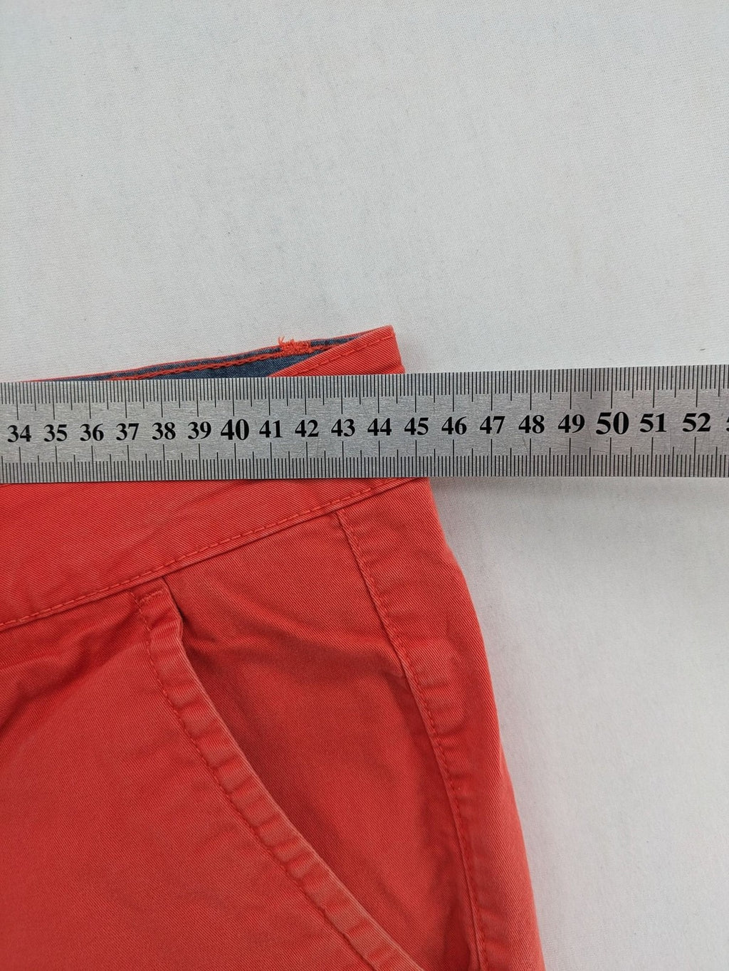 Chino orange shorts flat front with Est. 1921 label and comfortable fit.