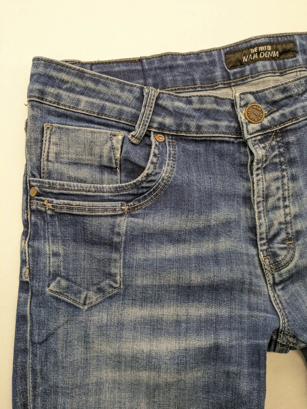 WAM Denim blue straight jeans with distressed details and button fly.