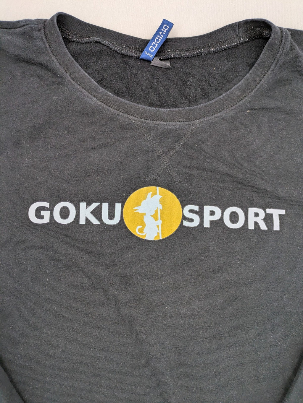Dragon Ball Z grey turtle neck jumper featuring "GOKU SPORT" graphic print, 100% cotton.