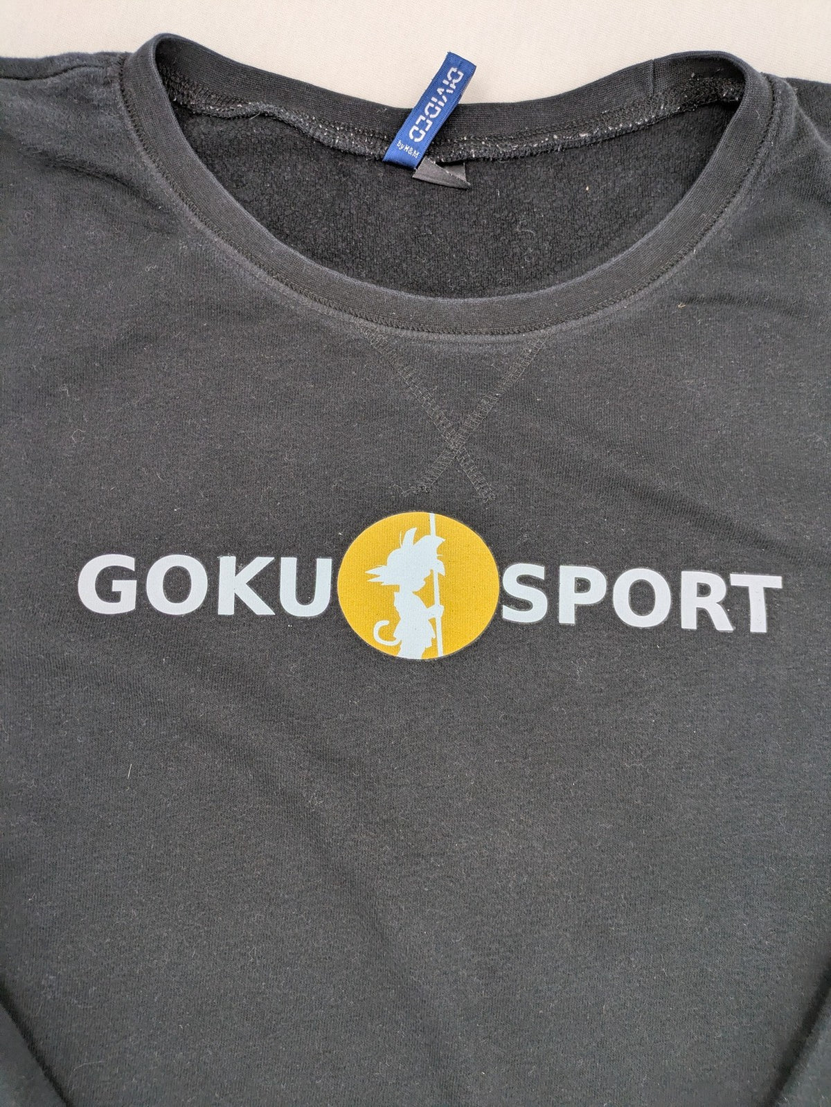 Dragon Ball Z grey turtle neck jumper featuring "GOKU SPORT" graphic print, 100% cotton.