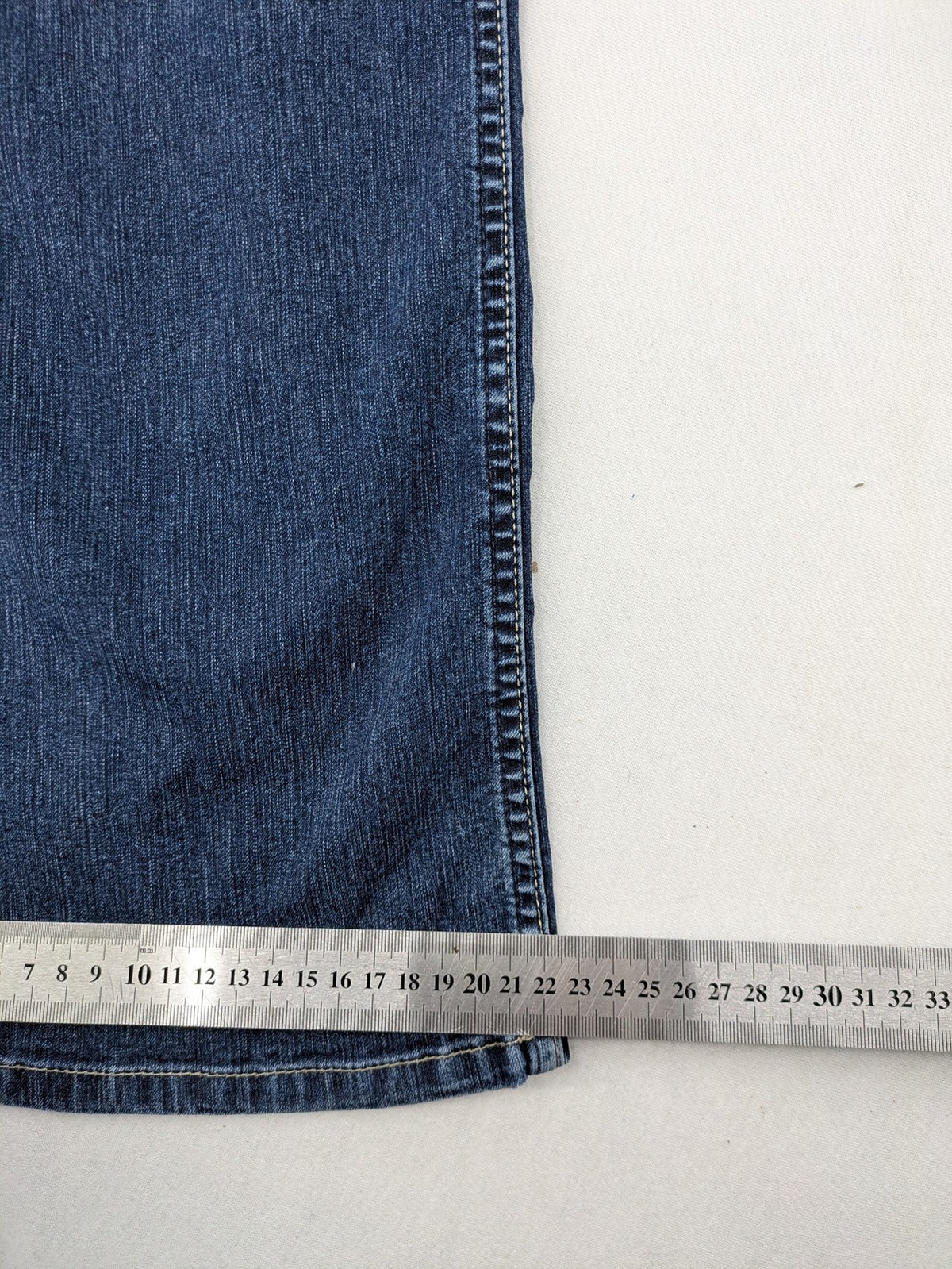 Mustang blue bootcut jeans with custom painted floral designs on both legs.
