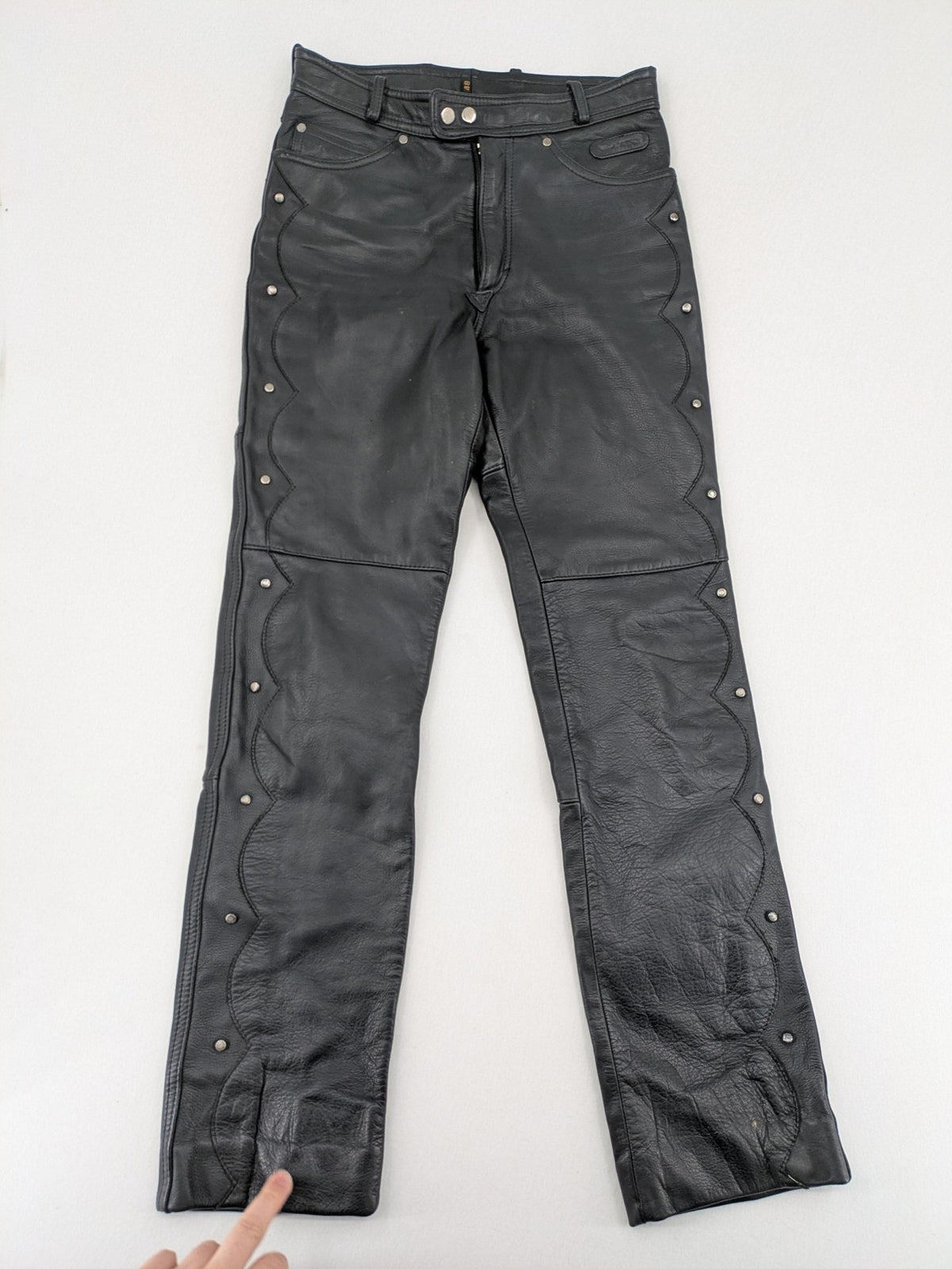 Hein Gericke black leather chaps with studs and wavy decorative seams.