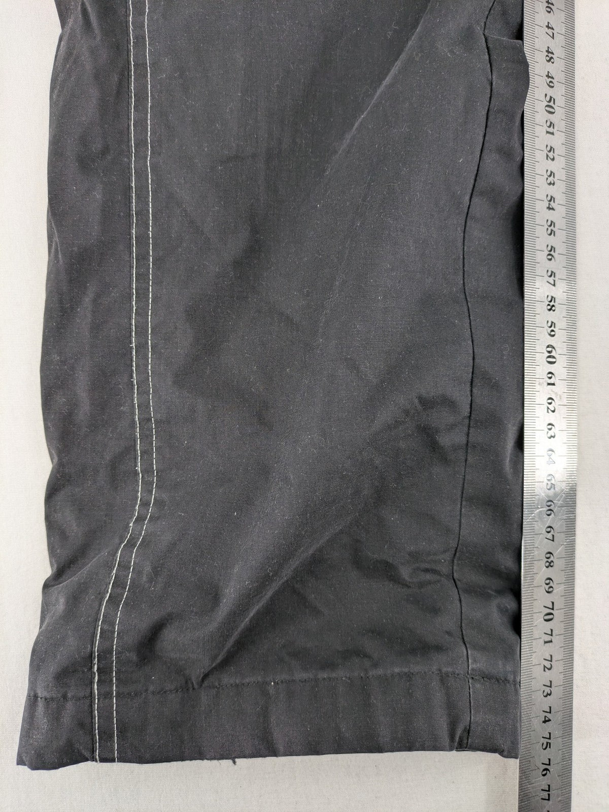 Jack Wolfskin grey outdoor pants with embroidered logo and side zip pocket.