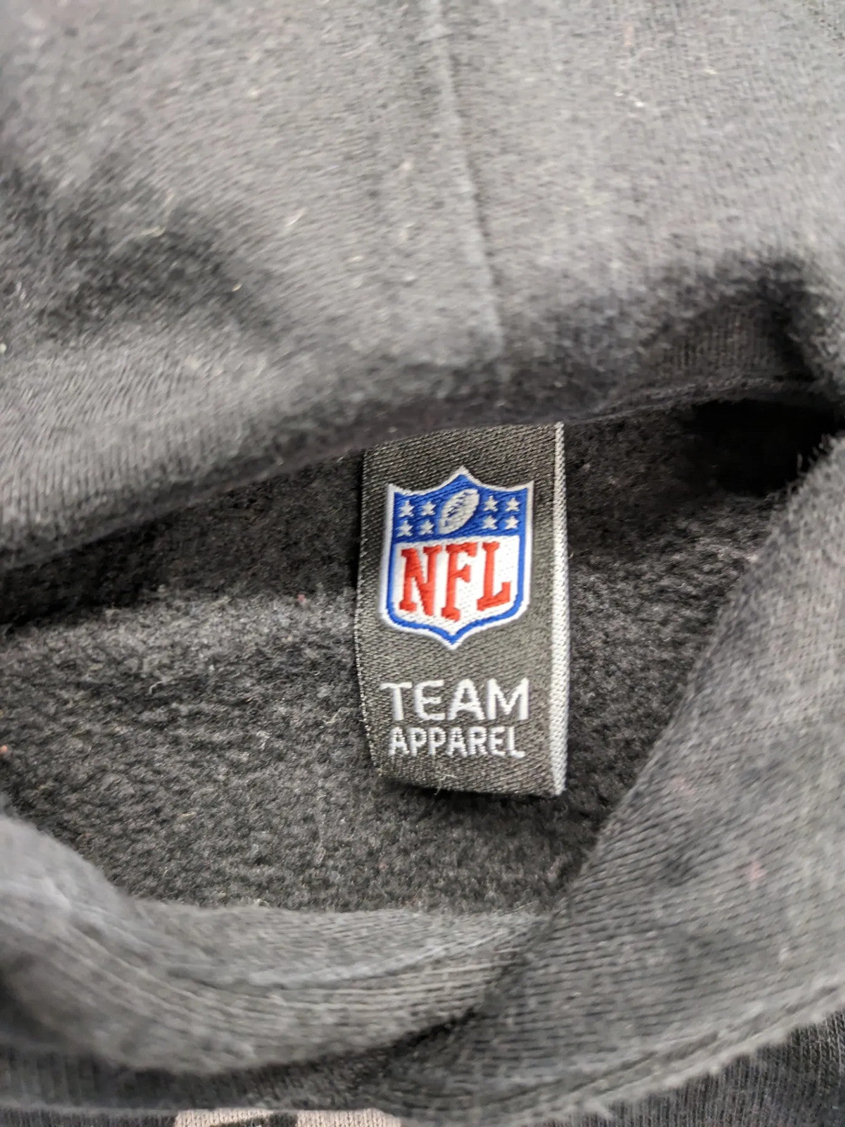NFL black hoodie all-over team logo print, adjustable hood, cotton blend material.