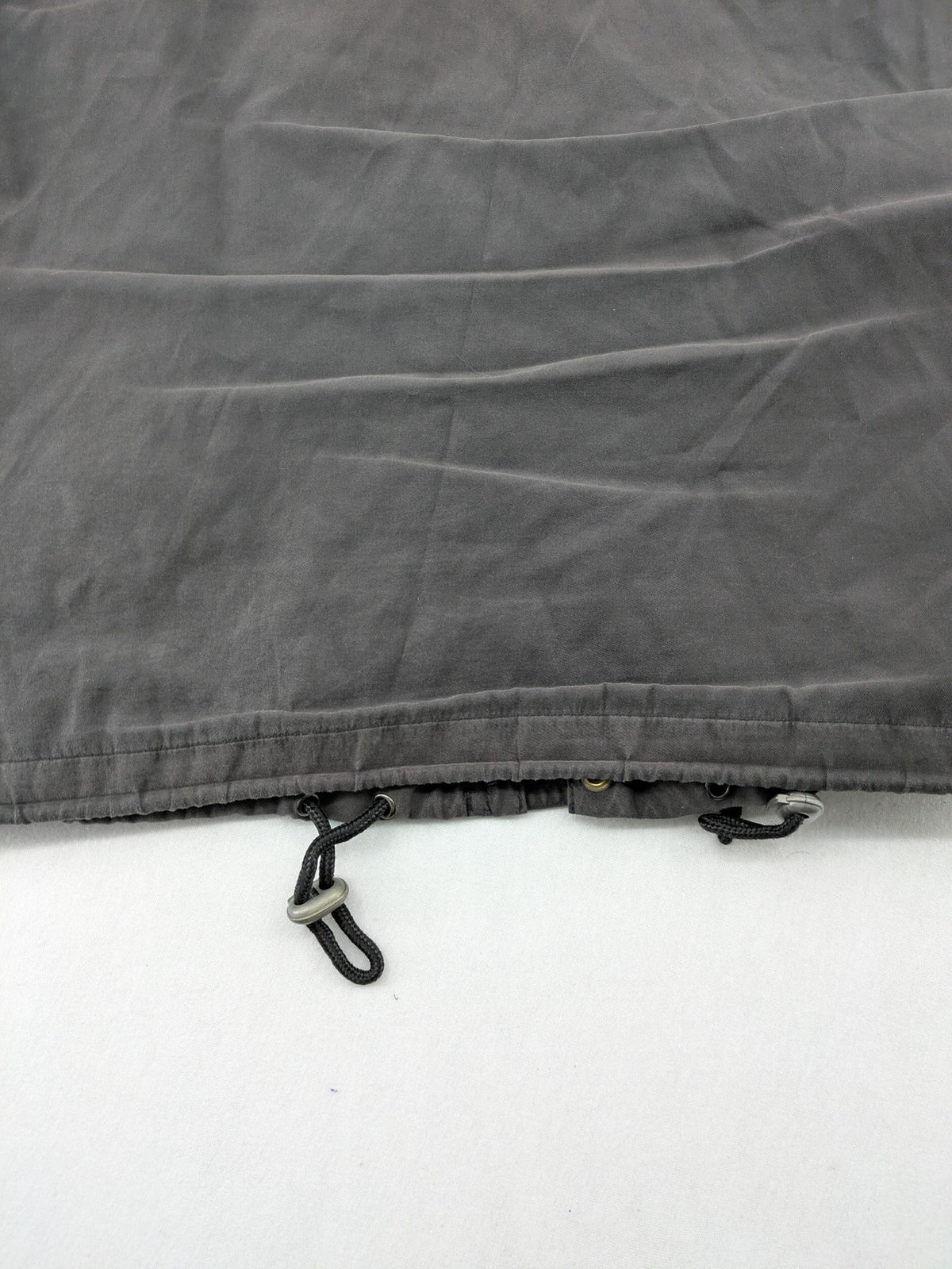 Barisal grey coat with hood, cargo pockets, and checkered lining detail.