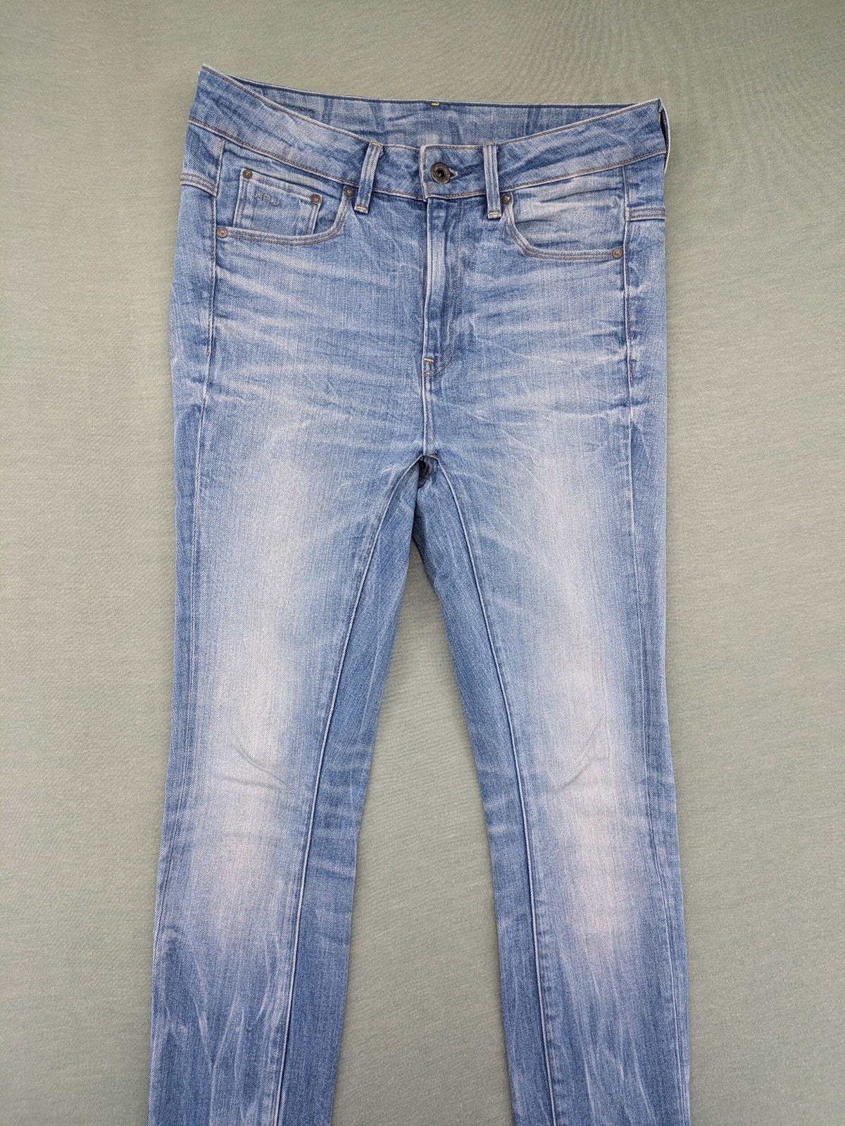 G-Star Raw blue slim skinny jeans with light wash and signature back zip pocket.