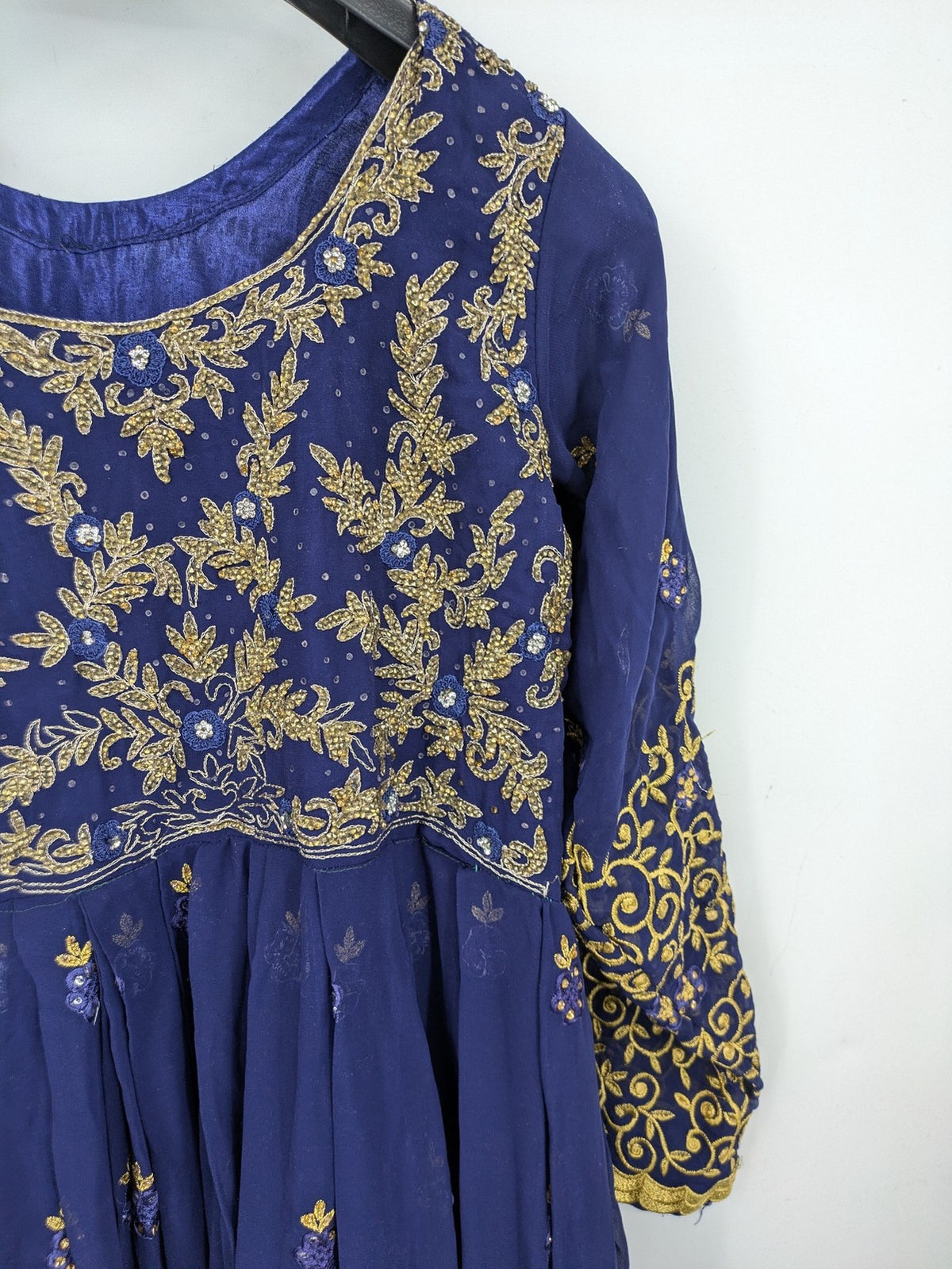 Bollywood bridal party dress gold with intricate blue embroidery and flowing Anarkali silhouette.
