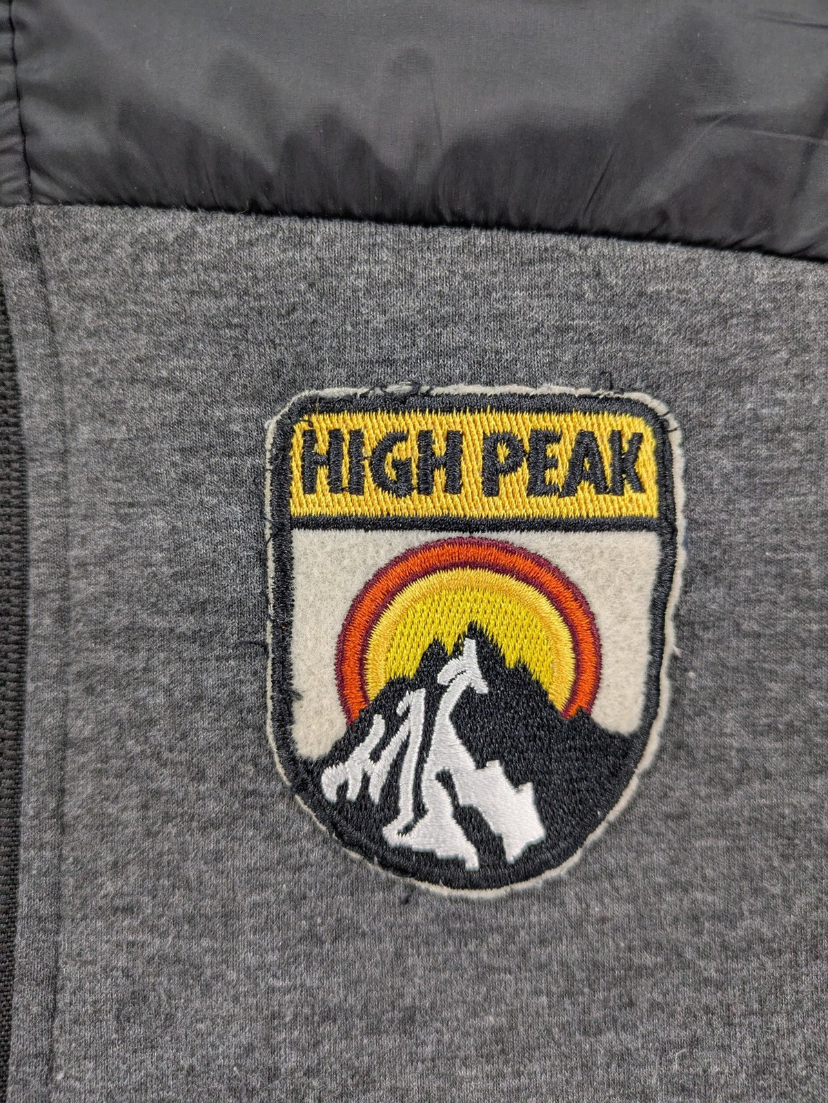 Energetics hybrid jacket black grey with High Peak patch and zip-up design.