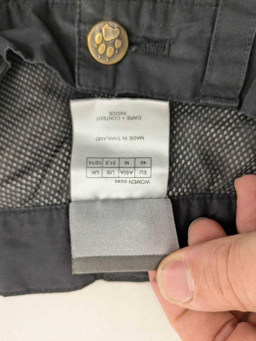 Jack Wolfskin grey outdoor pants with embroidered logo and side zip pocket.