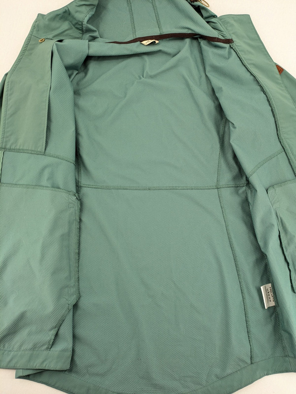 Frilufts green softshell jacket with hood, longline design, durable zipper, practical zip pockets.