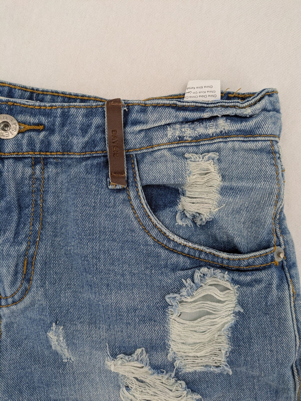 Daysie blue boyfriend jeans shorts with distressed rips and classic 5-pocket design.