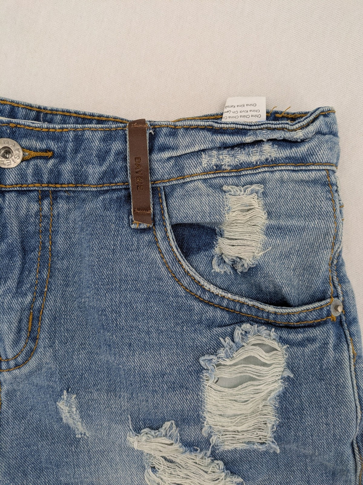 Daysie blue boyfriend jeans shorts with distressed rips and classic 5-pocket design.