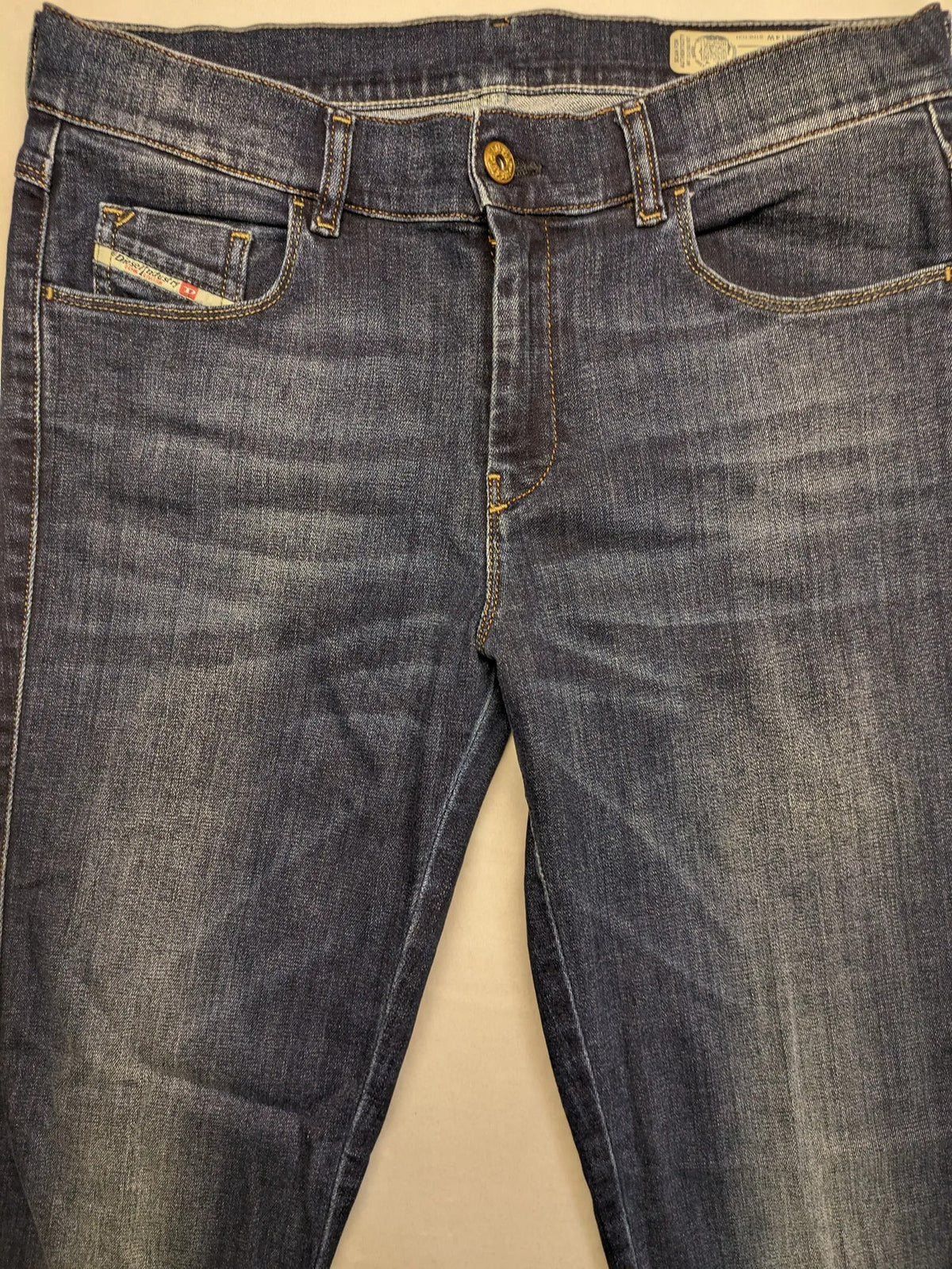 Diesel blue straight jeans with regular waist, dark wash, and stretch material.
