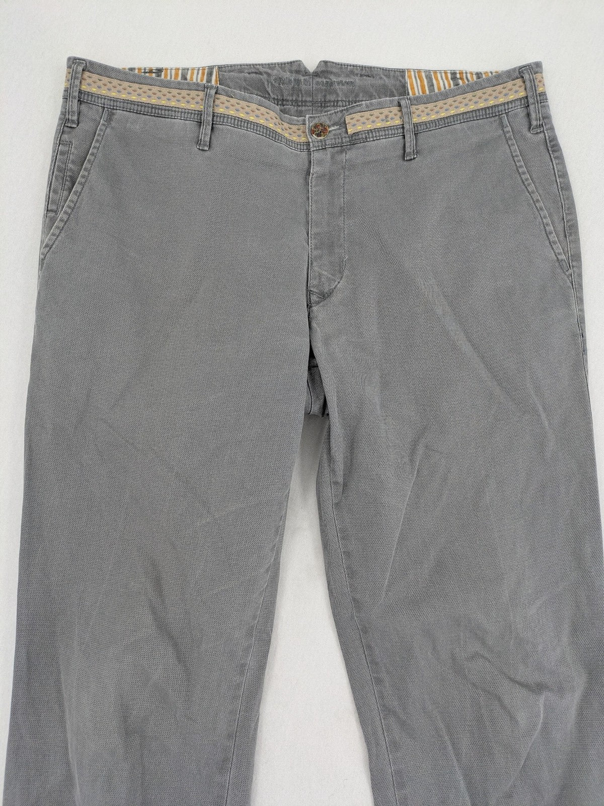 MMX grey chino pants with patterned interior lining and contrasting waistband, made from organic cotton.