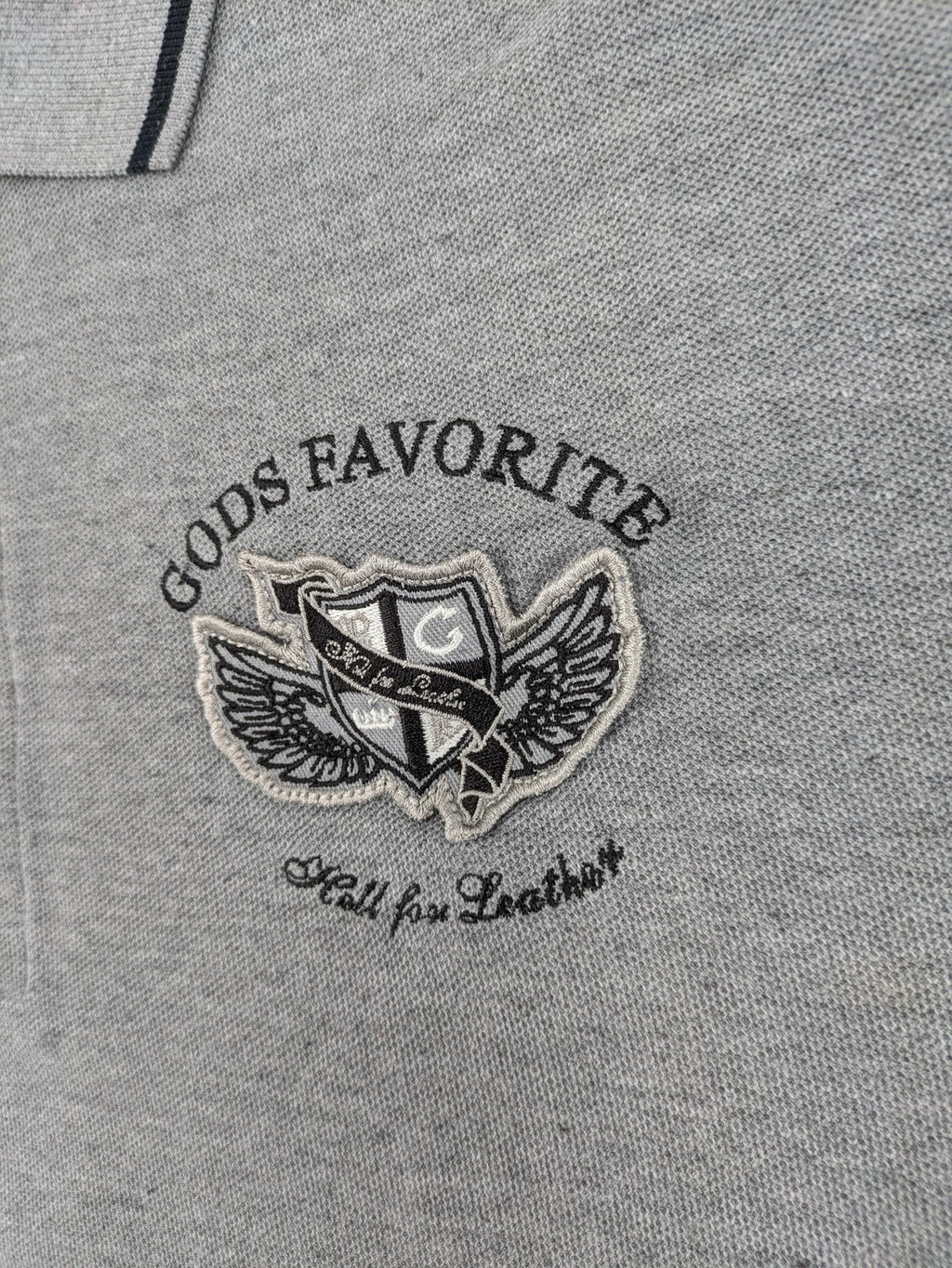 Götter & Helden grey polo shirt with "Gods Favorite" embroidery and contrasting collar details.