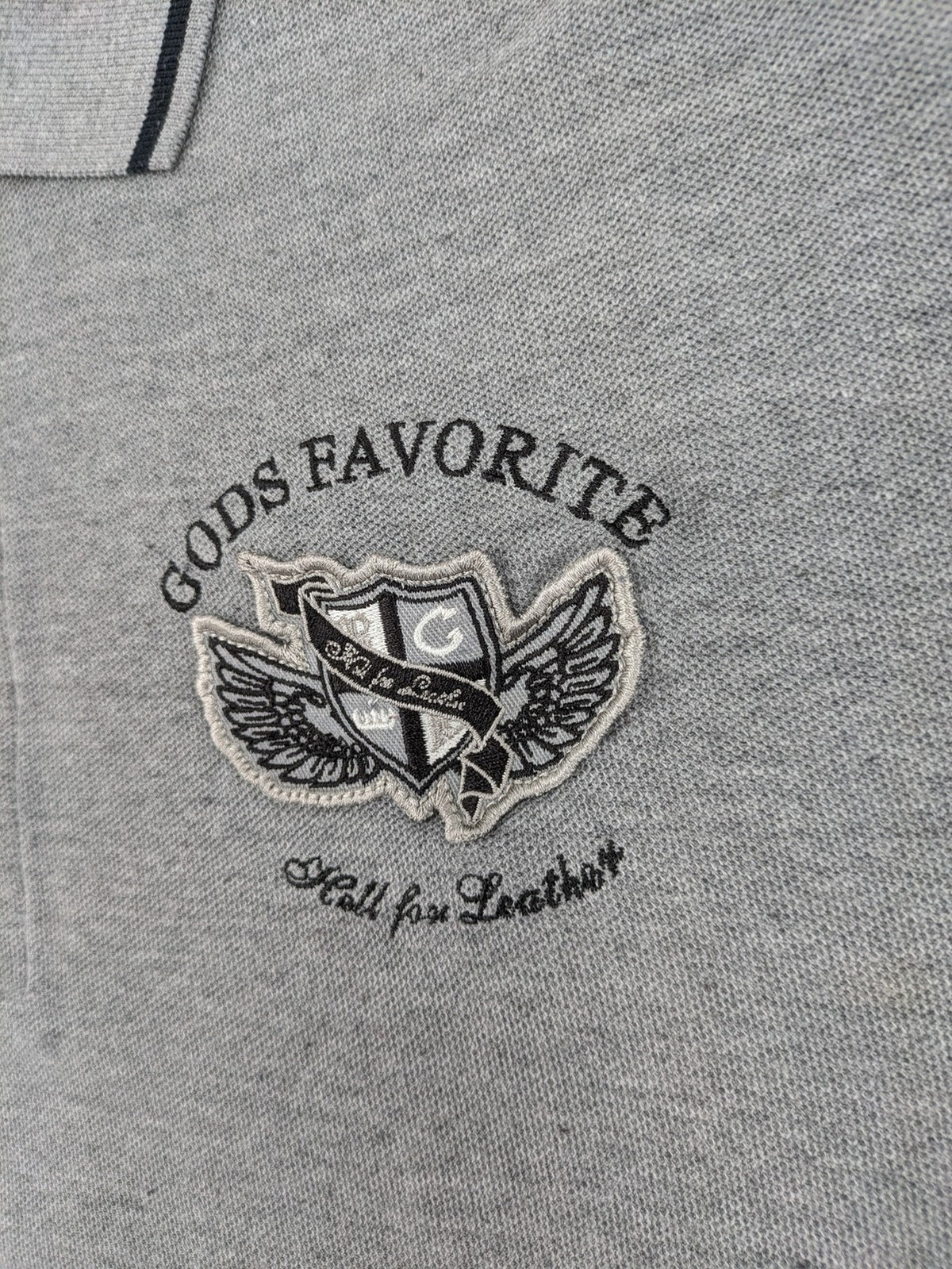 Götter & Helden grey polo shirt with "Gods Favorite" embroidery and contrasting collar details.