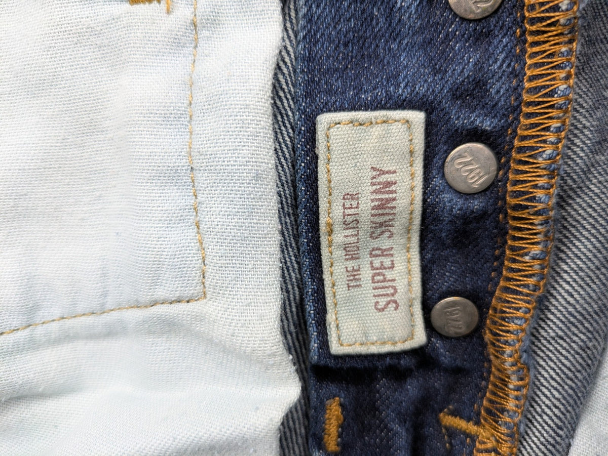 Hollister blue super skinny jeans medium wash button fly with faded details.